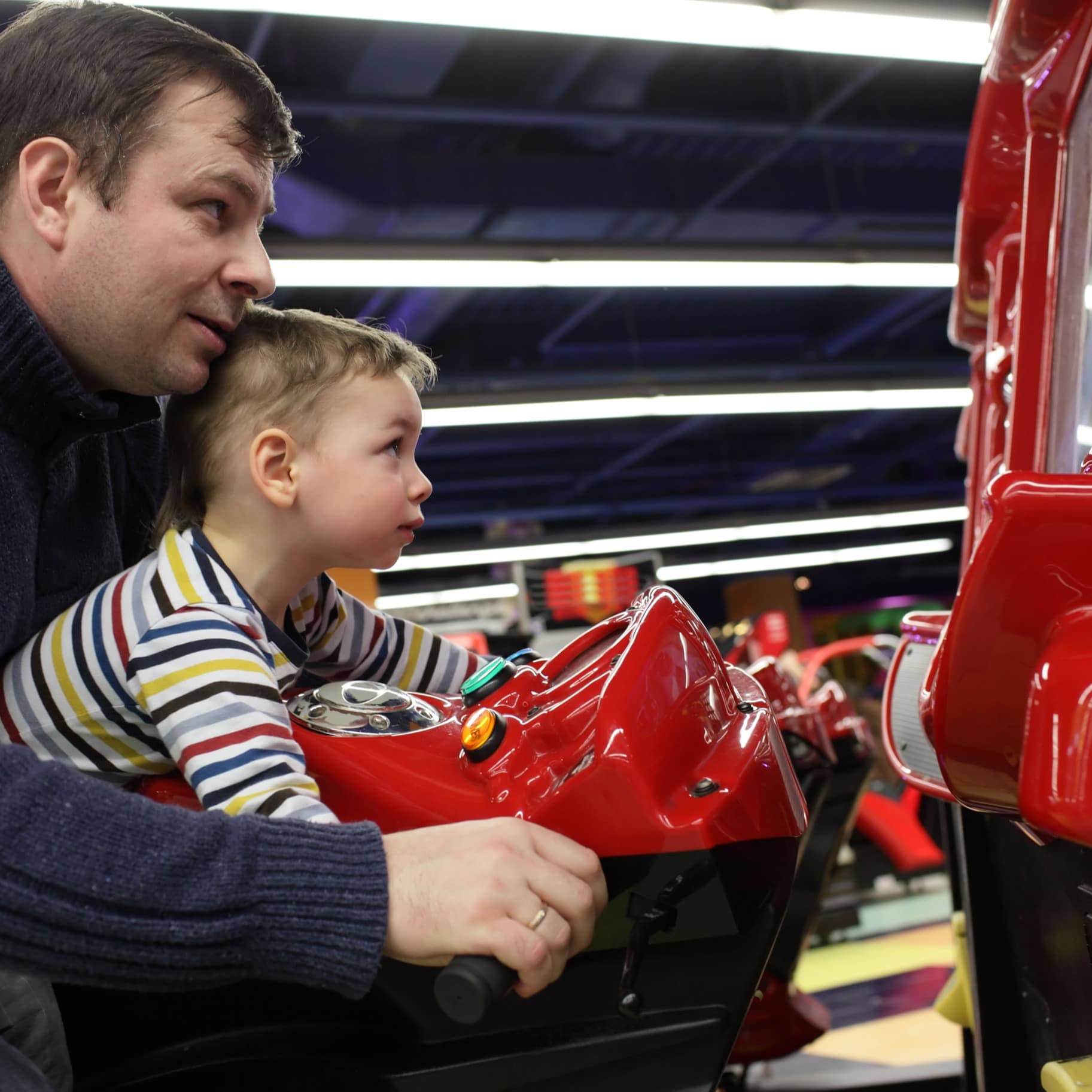 Father and son ride motorbike arcade game