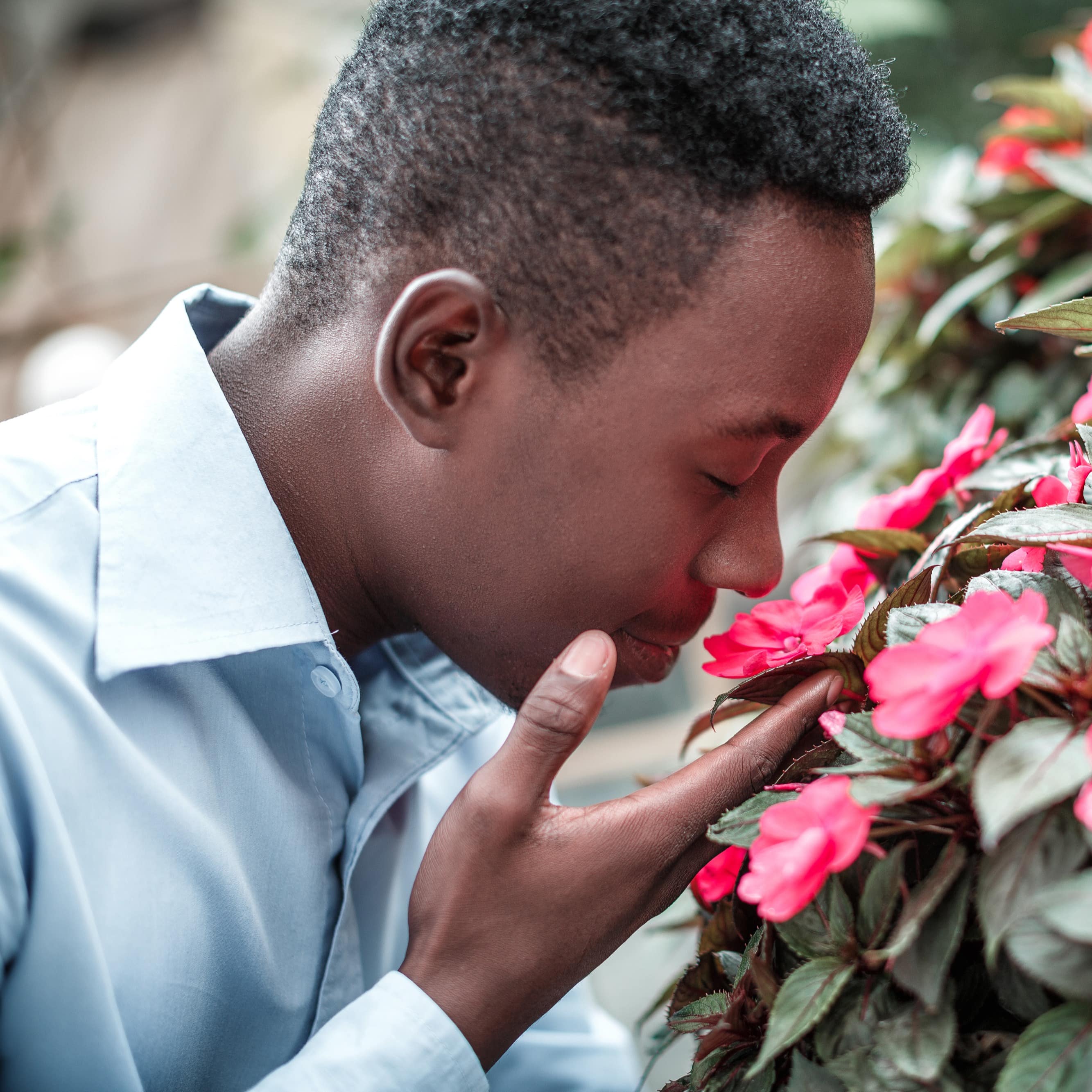 Man smelling flowers