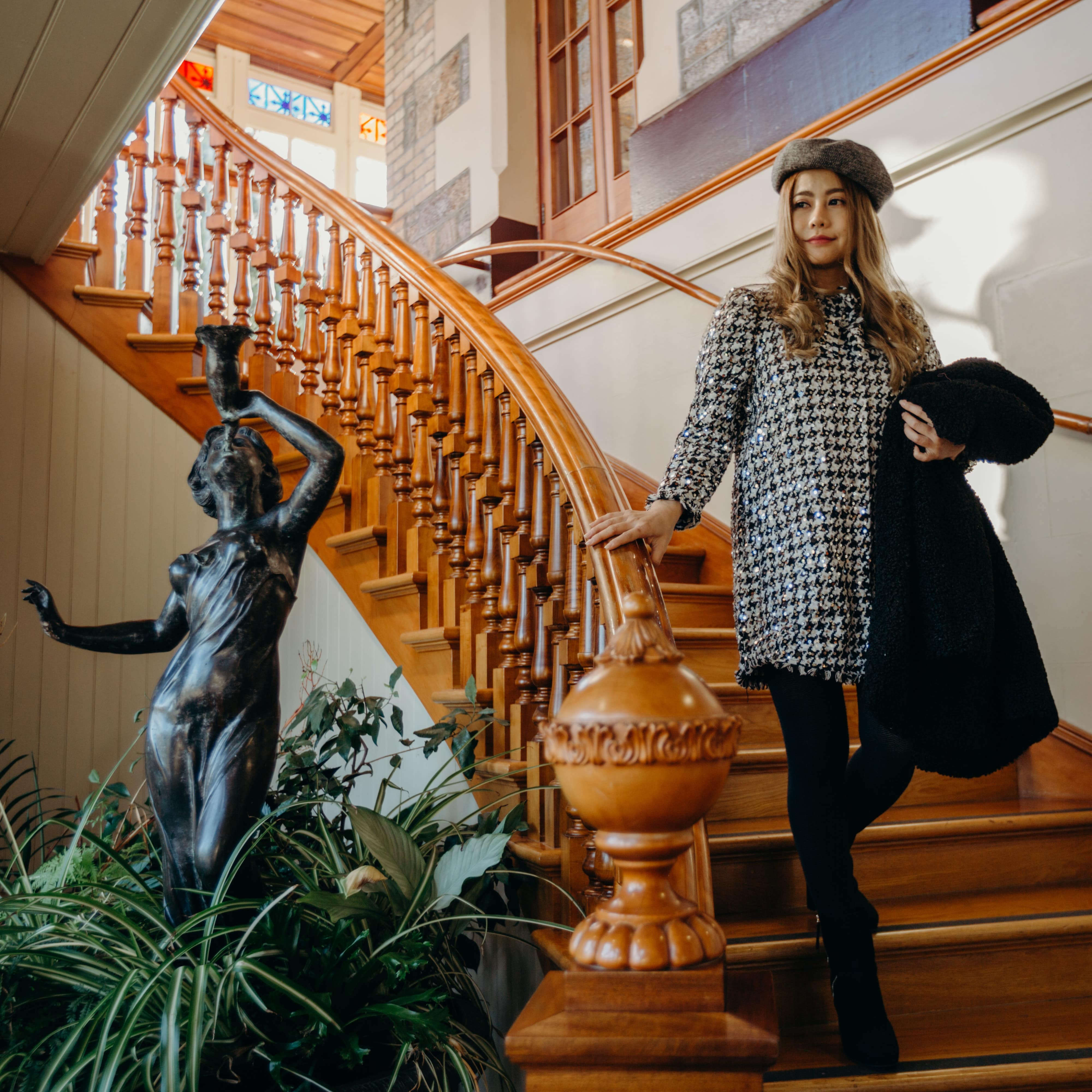 Woman descending stairs of Larnach Castle
