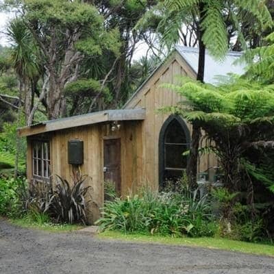 Main entry to a cottage surrounded by trees