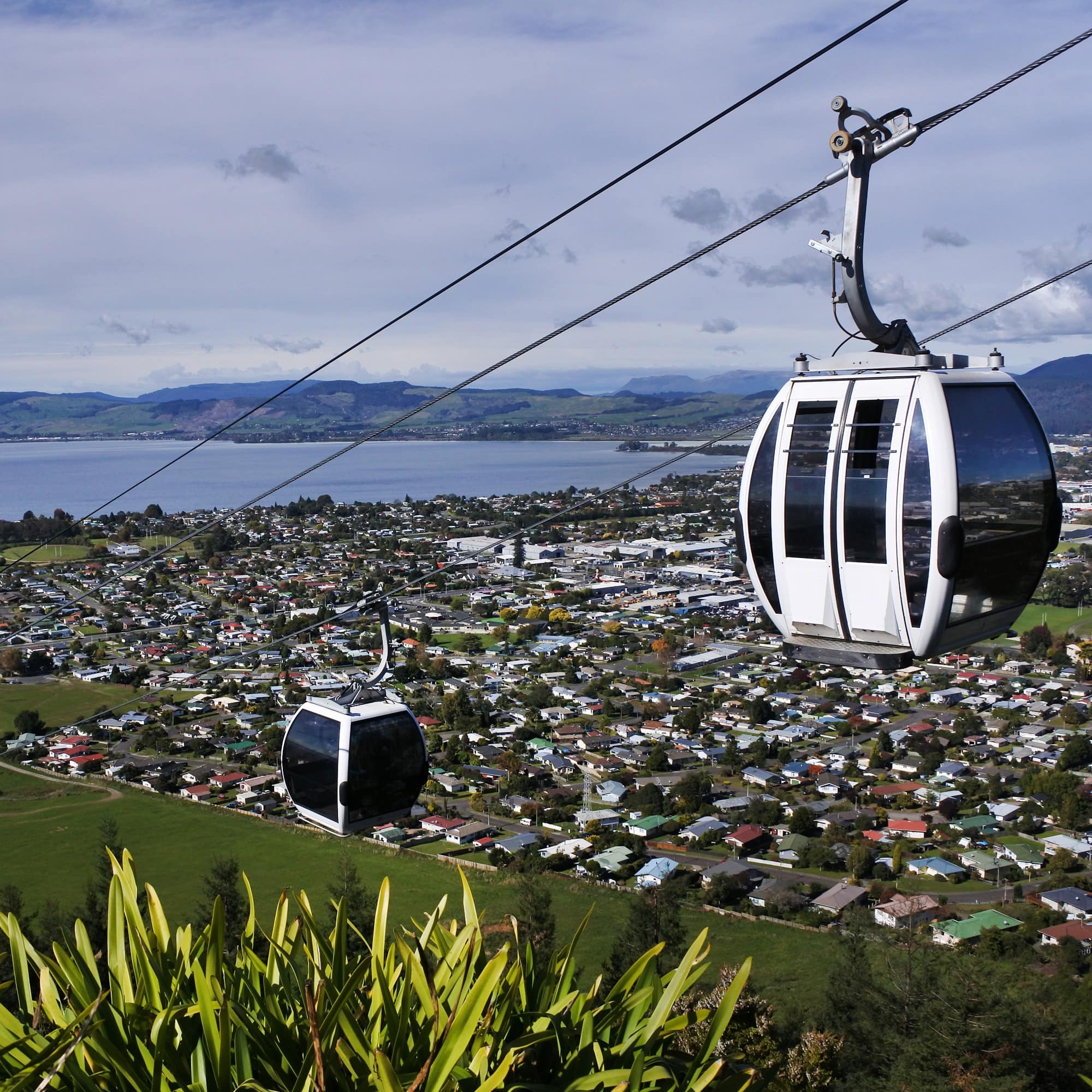 Two gondolas overlooking city