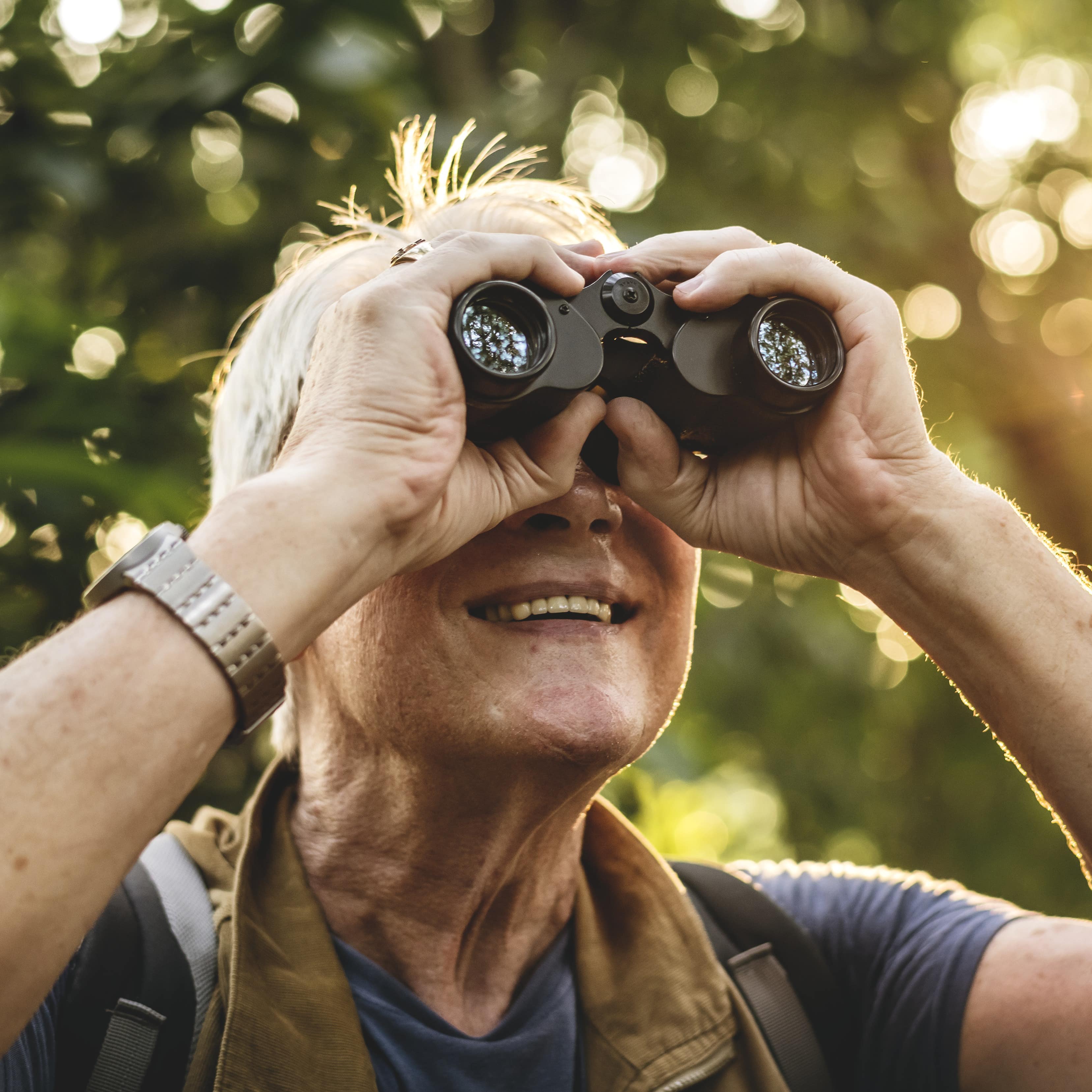 Mature woman bird watching through binoculars