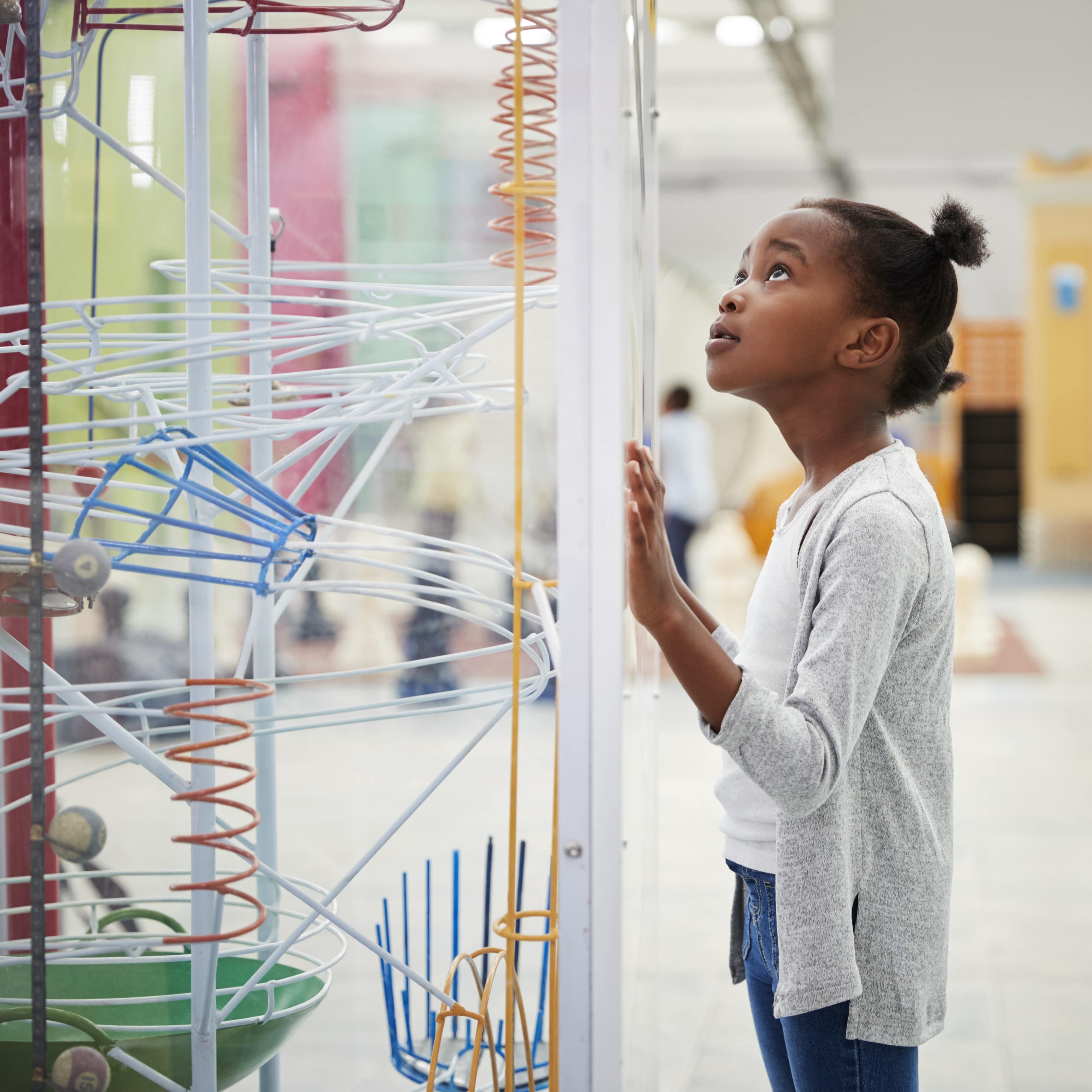 Little girl looking at a science exhibit