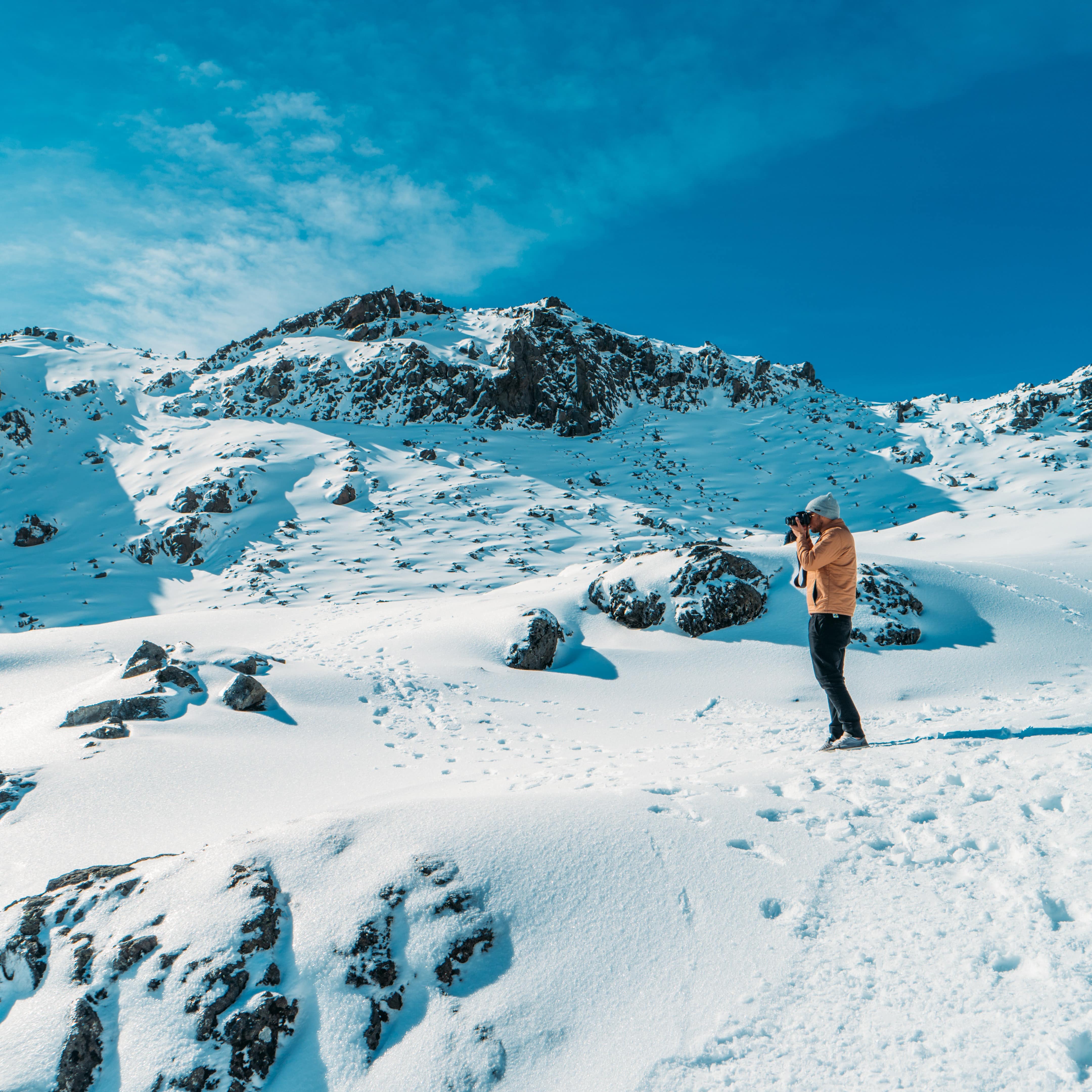 Person looking through the camera to take pictures on snow-covered Mount Ruapehu