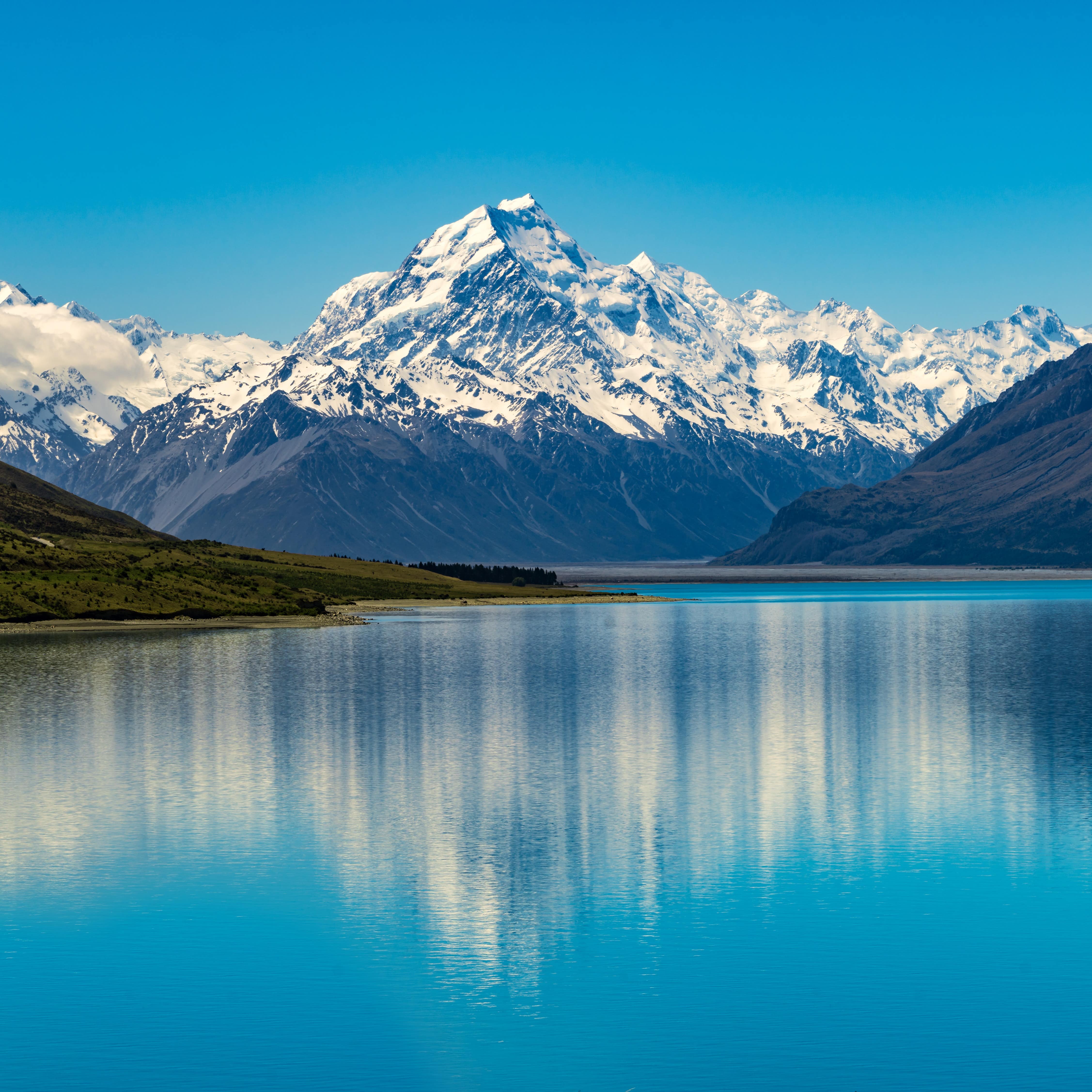 A beautiful lake surrounded by snow covered mountains.