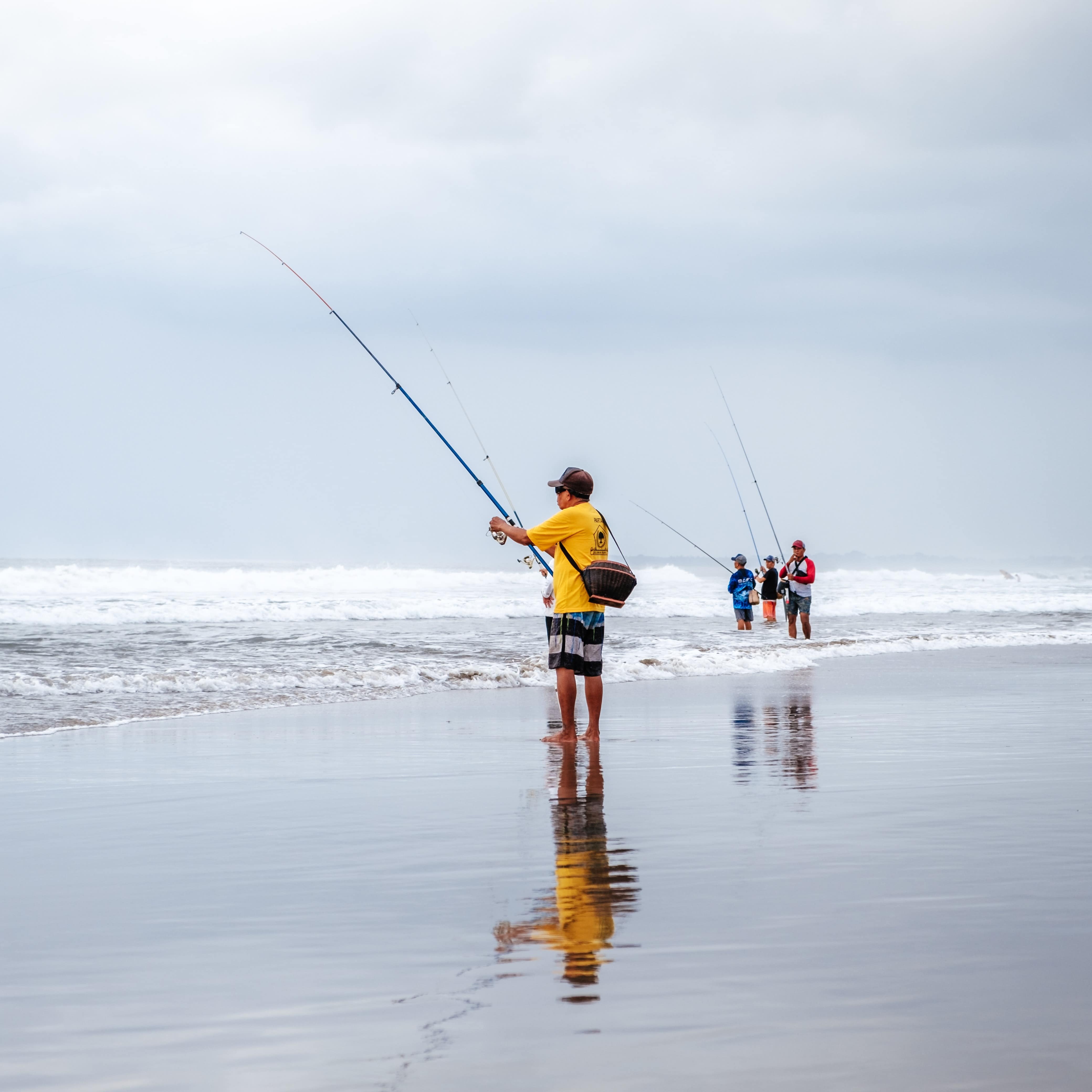 People fishing on the beach