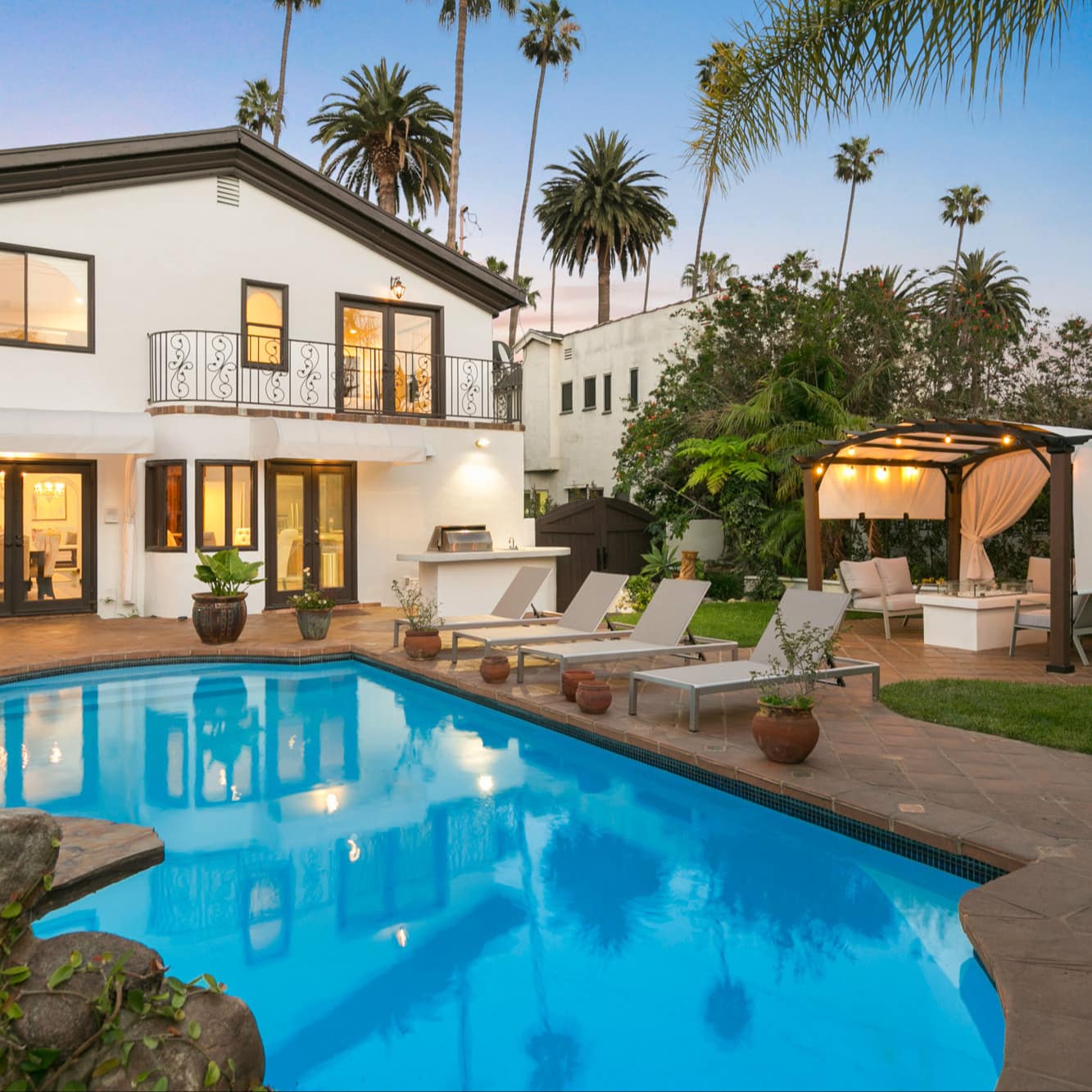 Los Angeles home with swimming pool, palm trees, and cabana