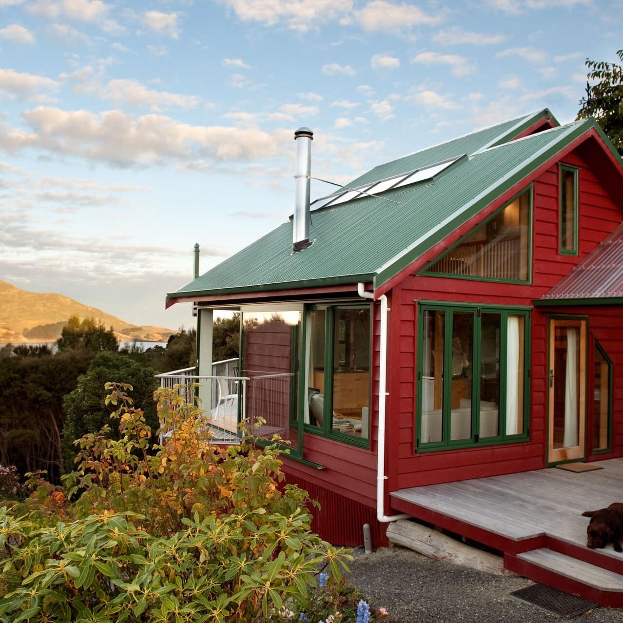Red and green garden retreat with a mountain skyline in the background