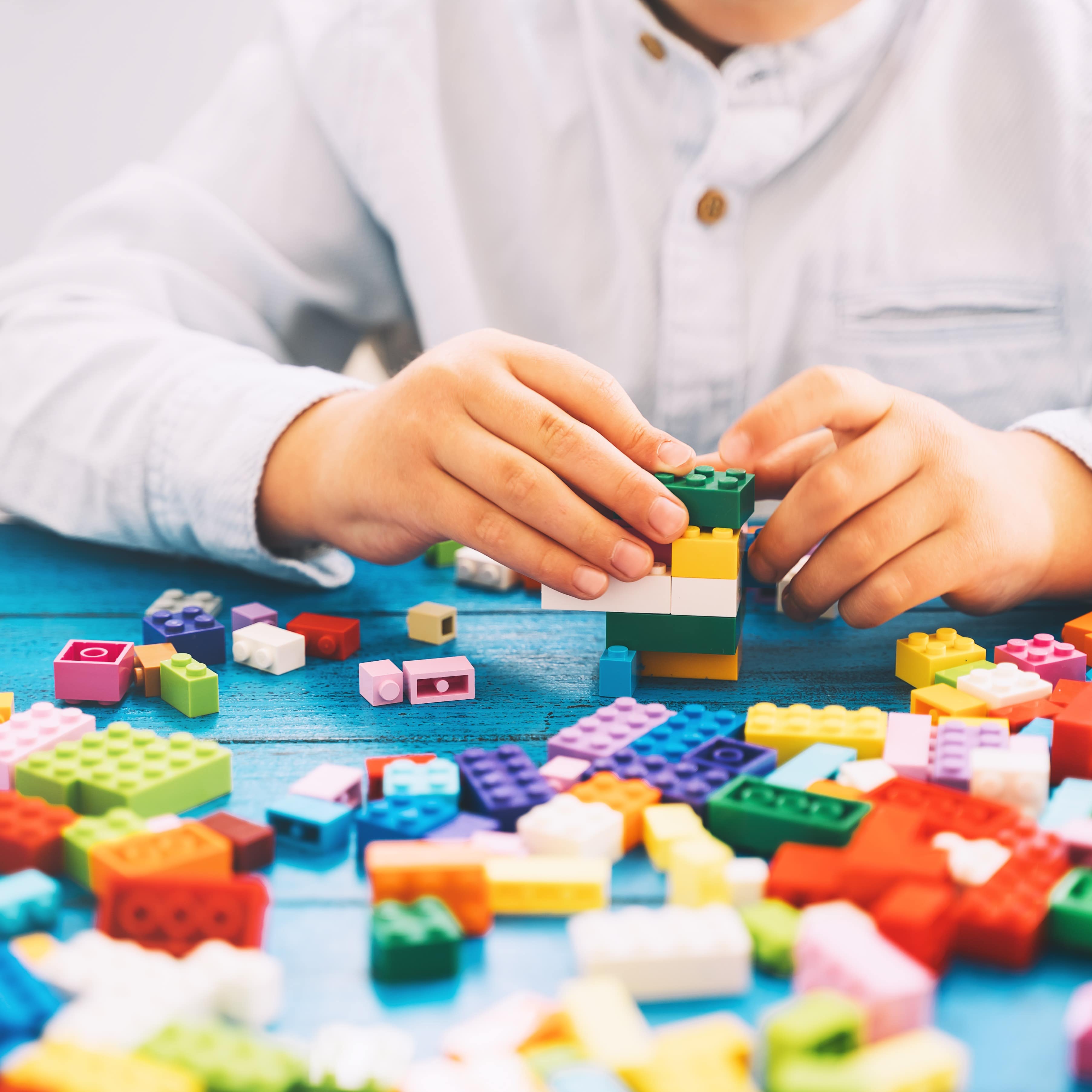 Child's hands playing with Legos