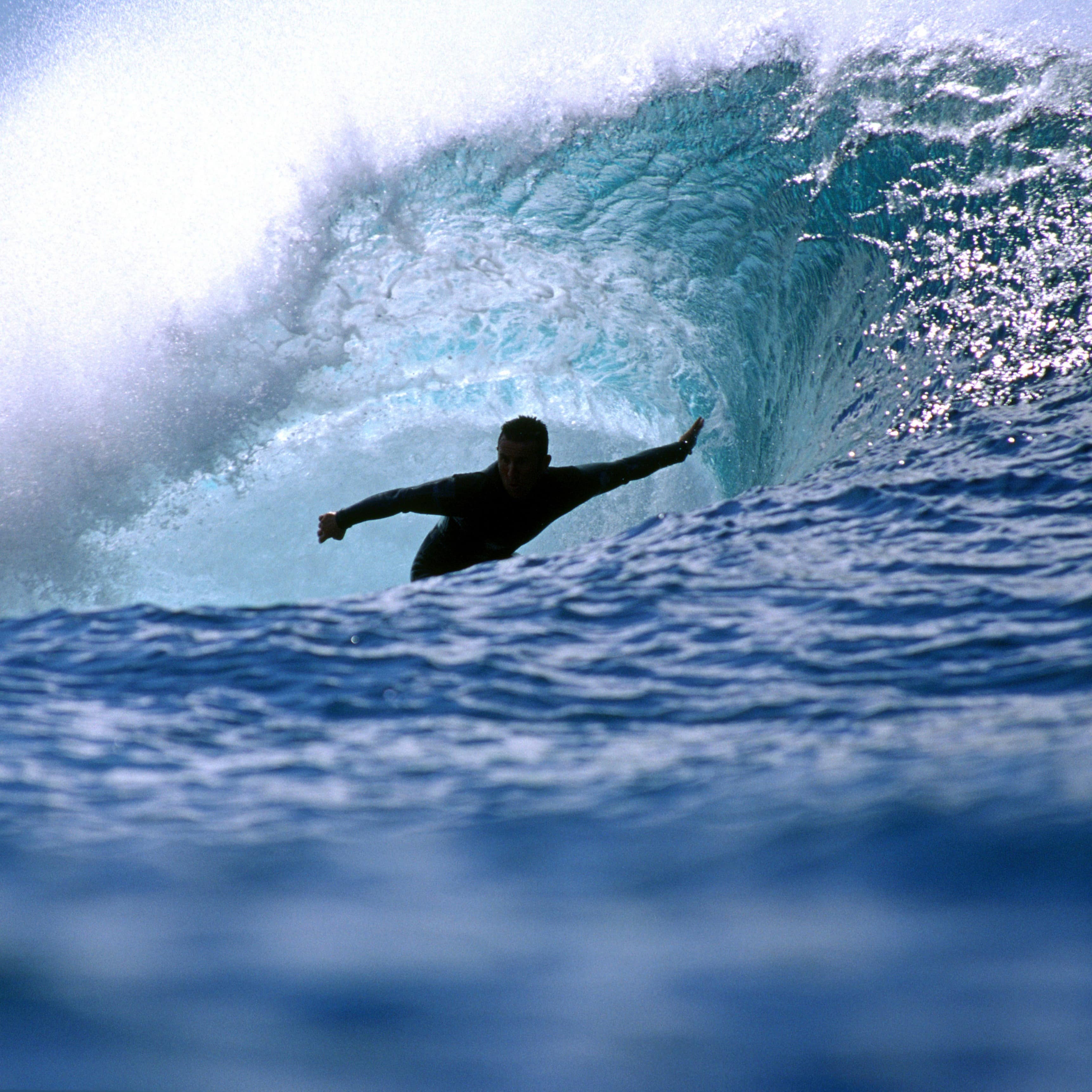 A surfer going through a wave tunnel.