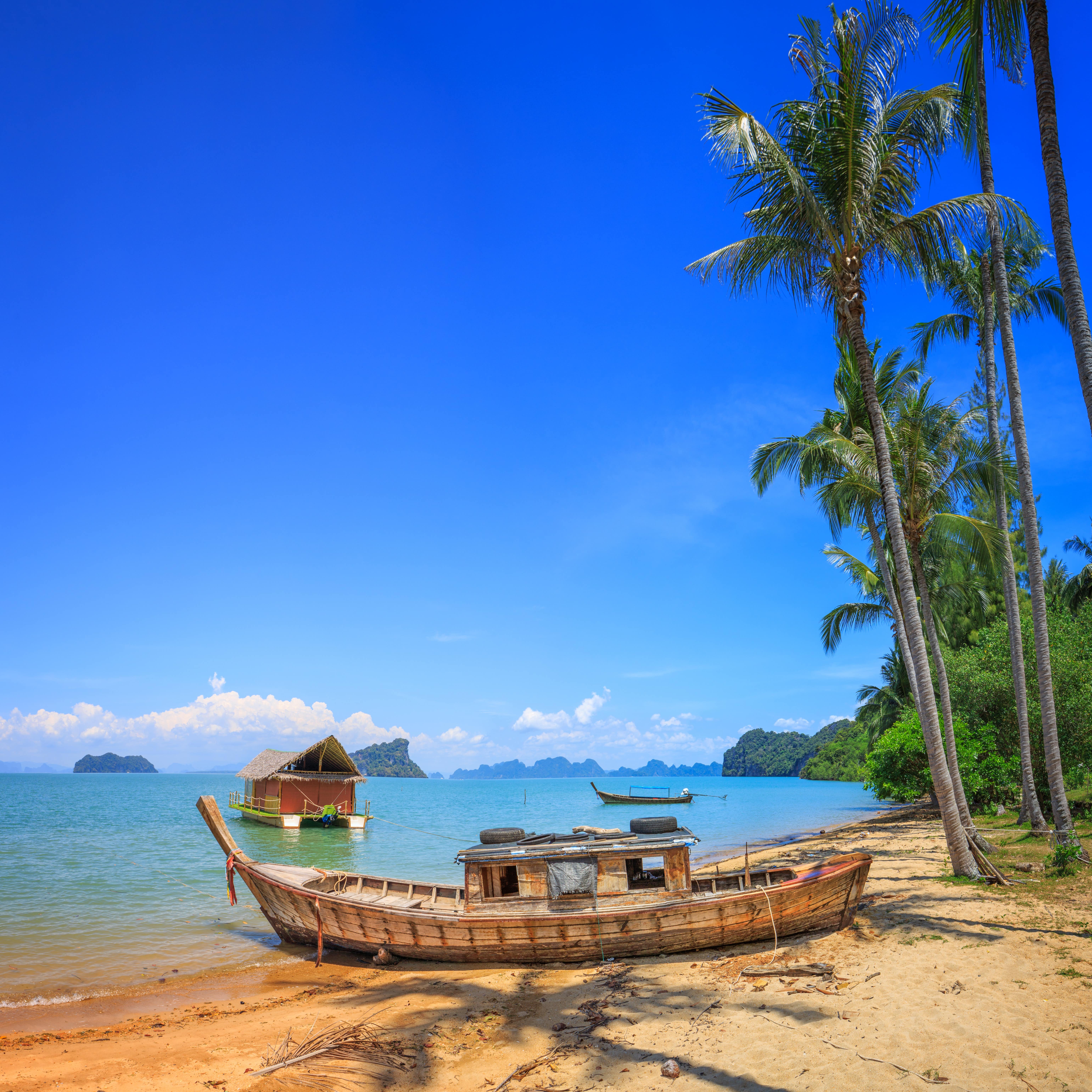 Old boat at the beach with palm trees in Koh Yao Noi, Thailand File