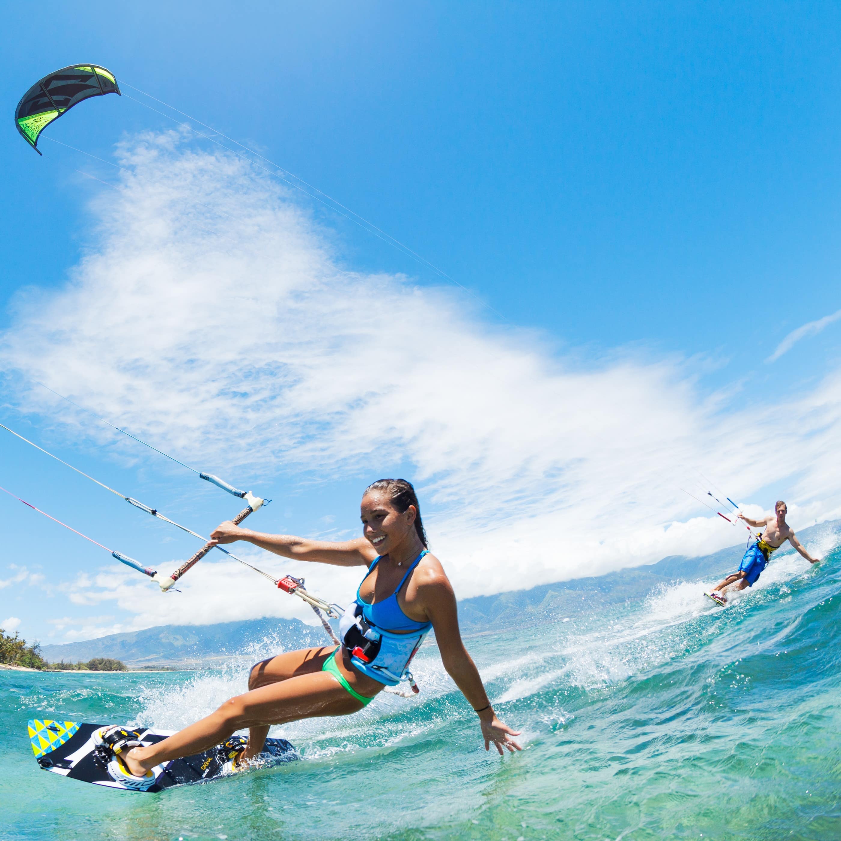 Man and woman kitesurfing