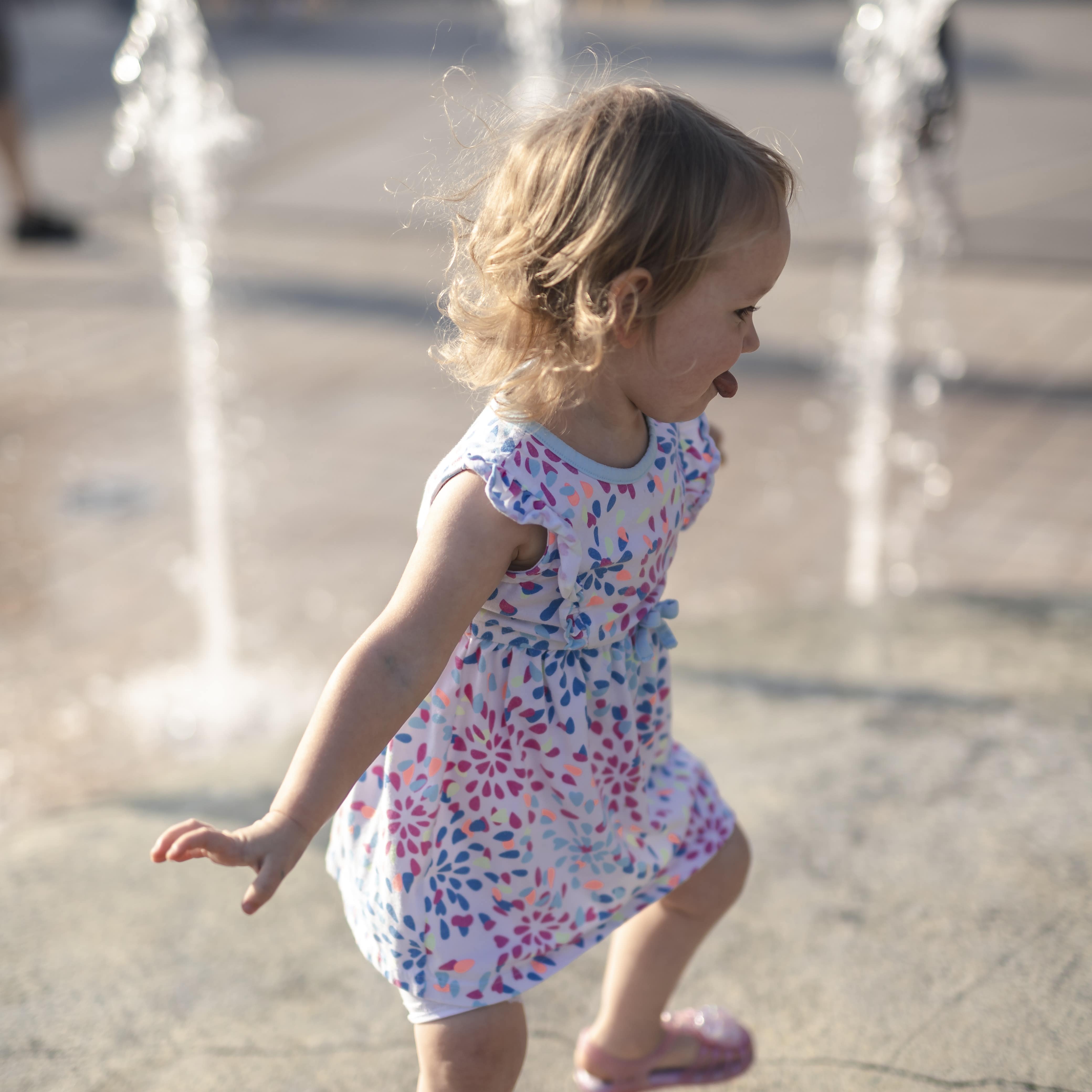 Little girl splashing in park