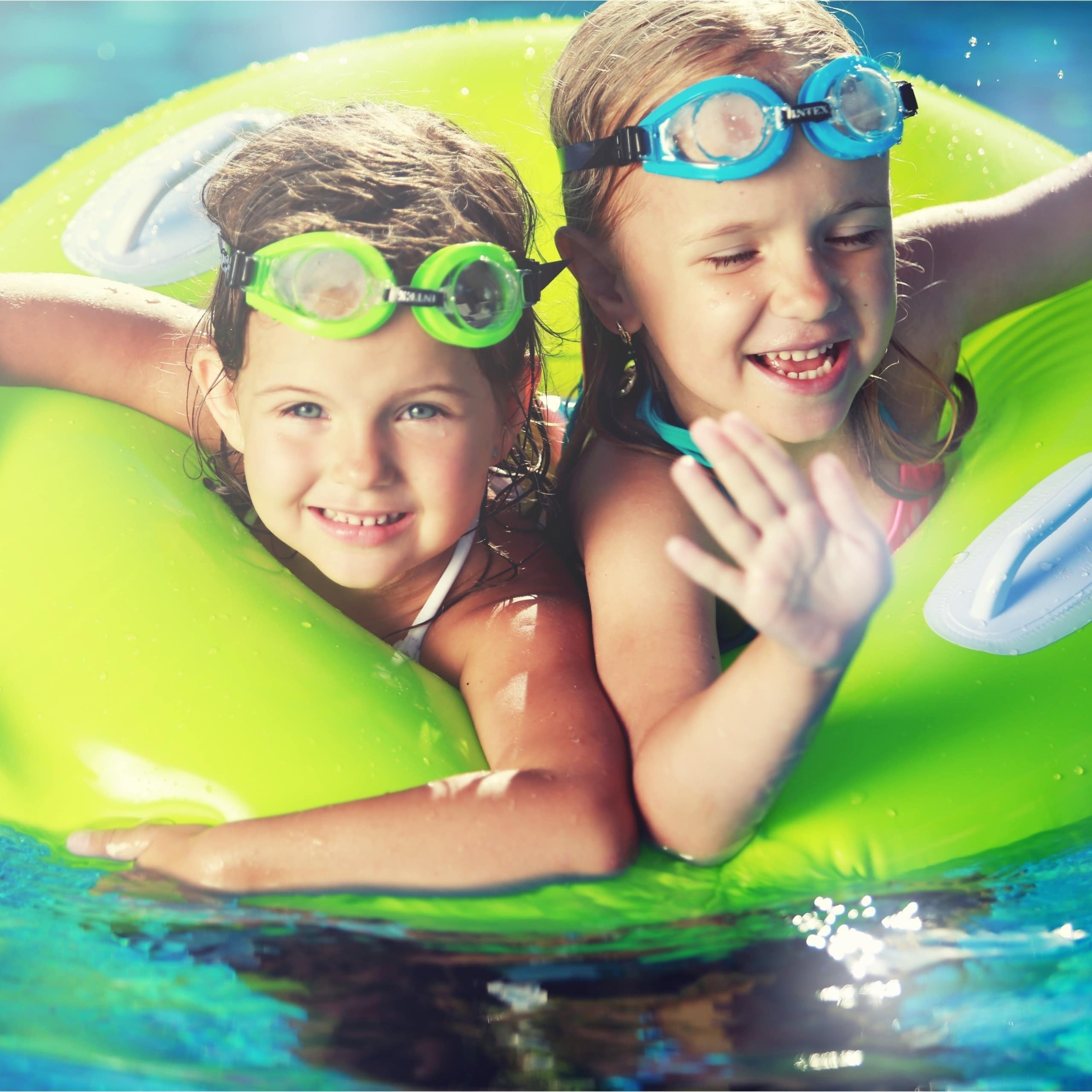 Two kids sharing an inflatable ring