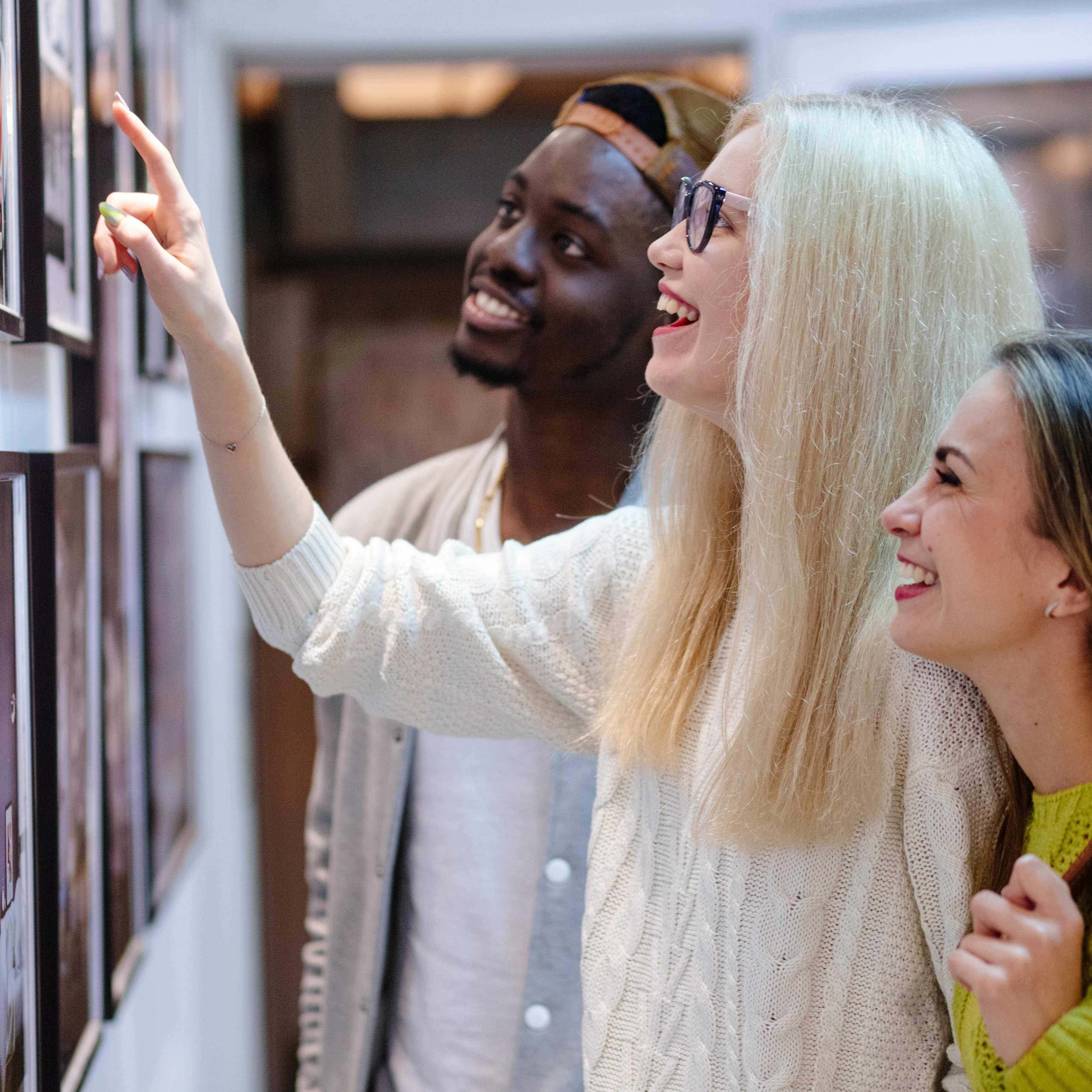 Three friends looking at art exhibit