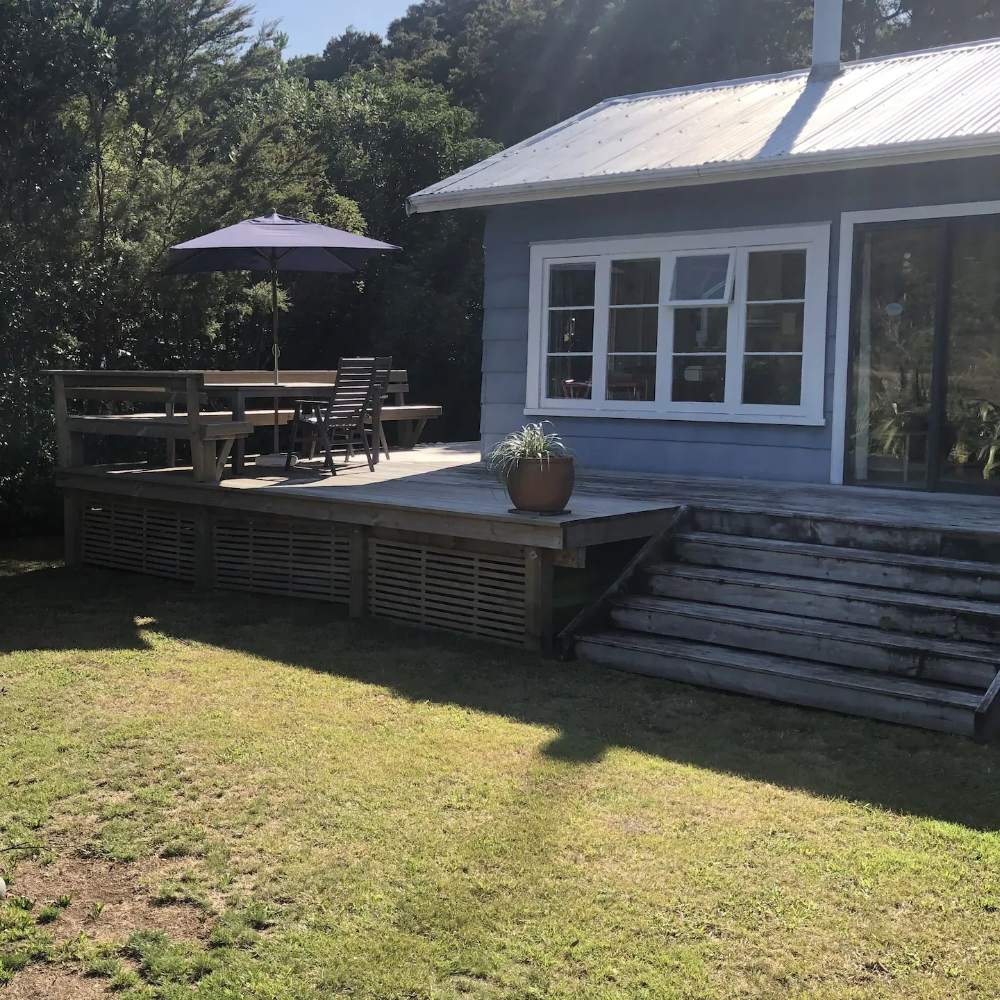 Backyard of small bach with a deck