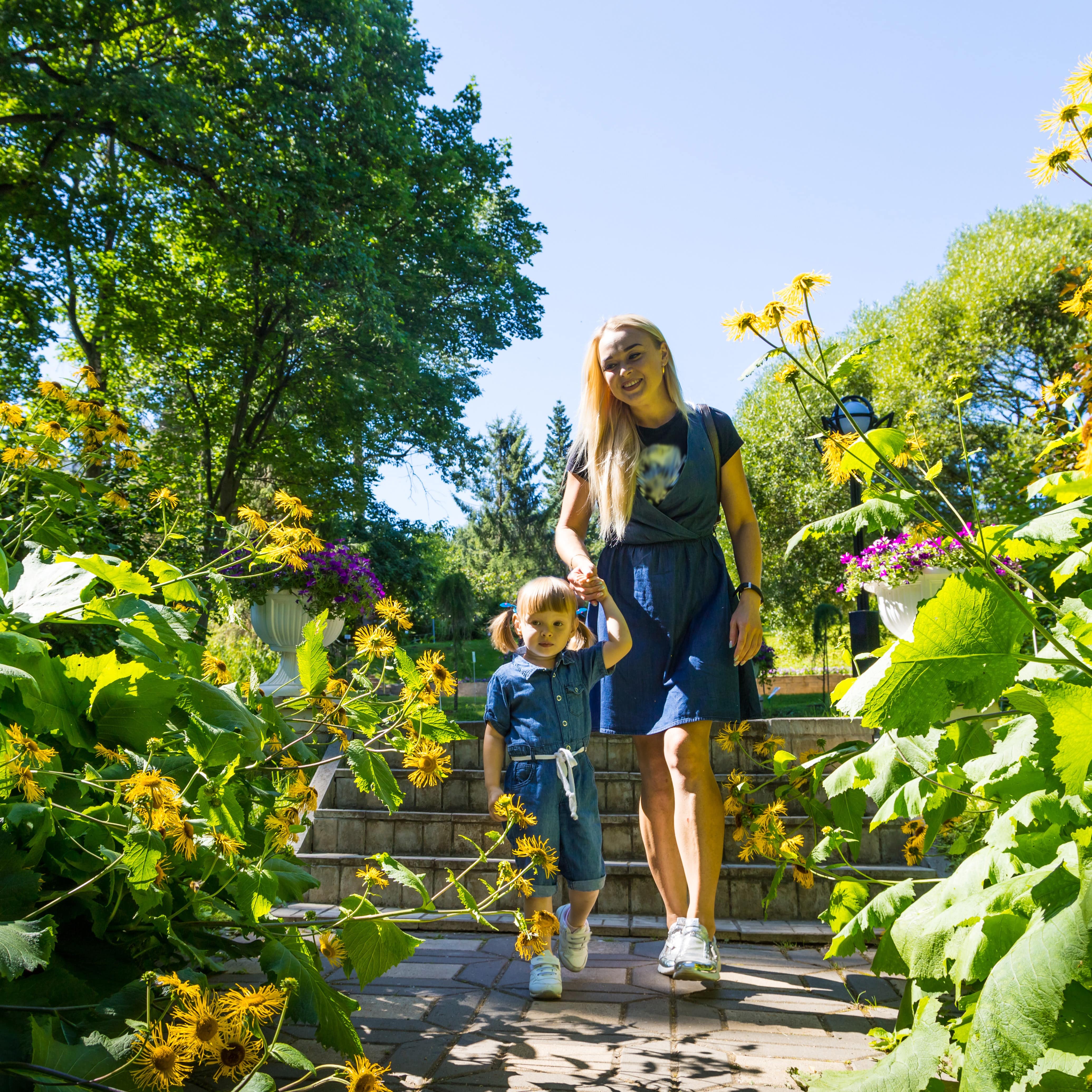 Mother and daughter walking through botanical garden