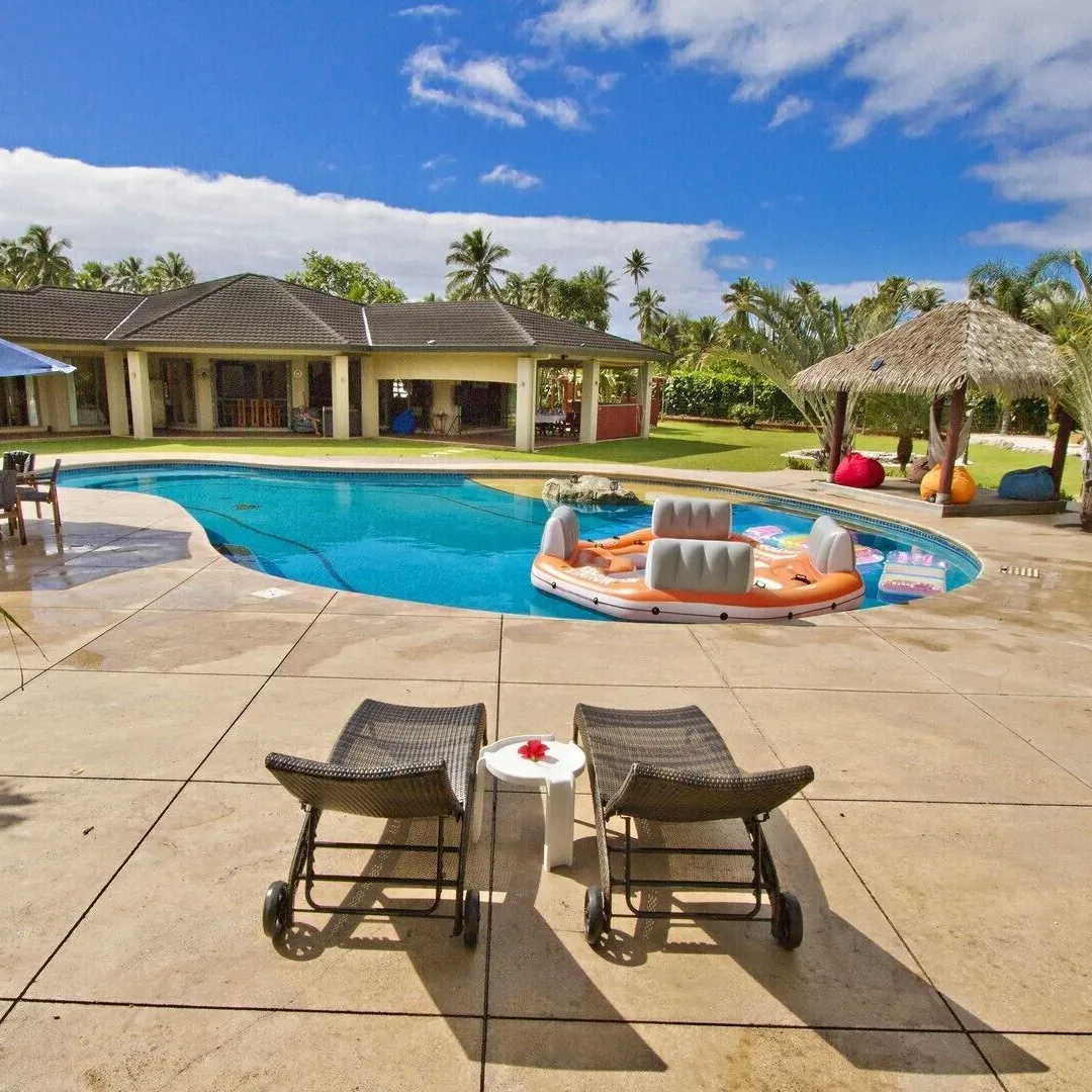 Lounge chairs and covered seating areas by the pool