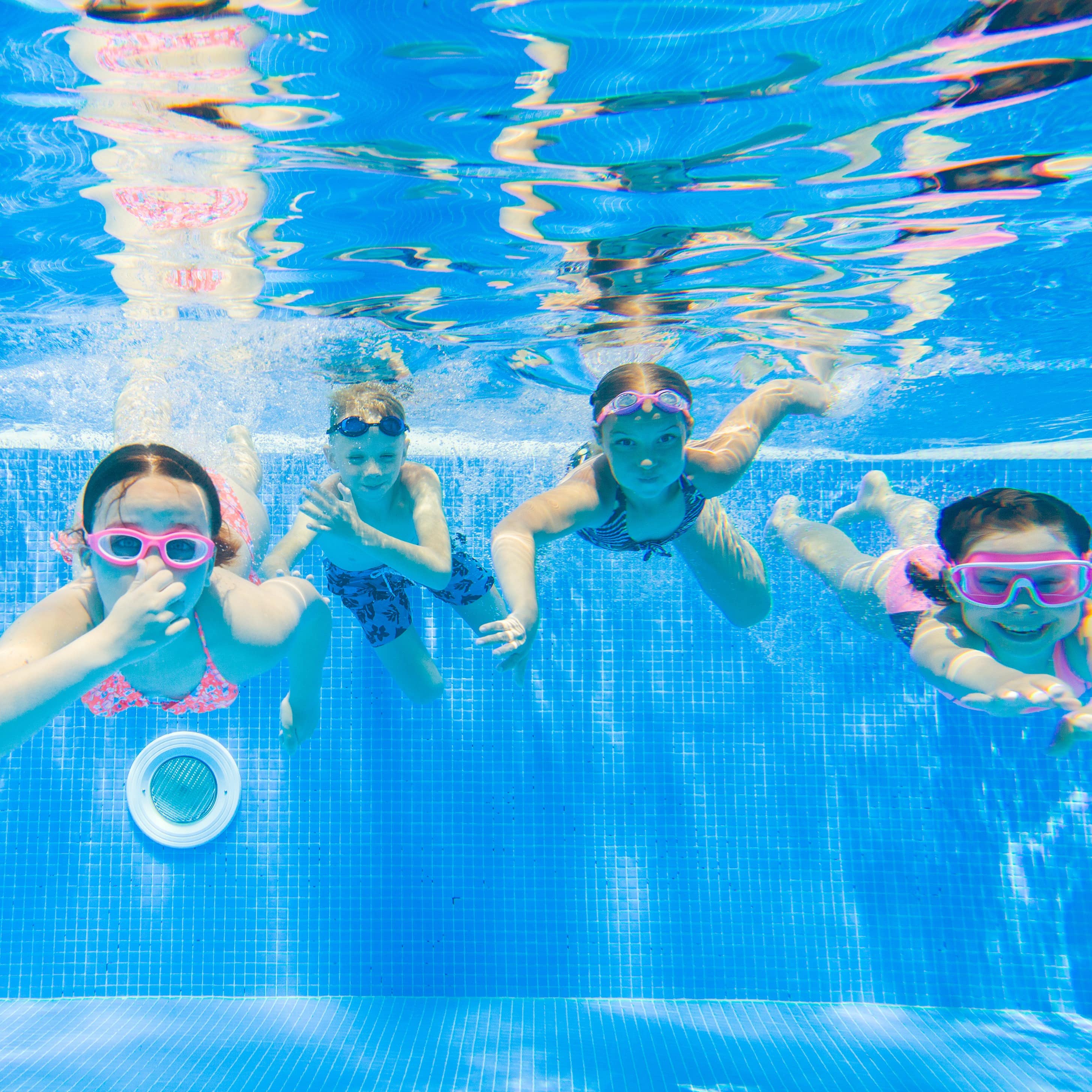 Five children swimming in pool