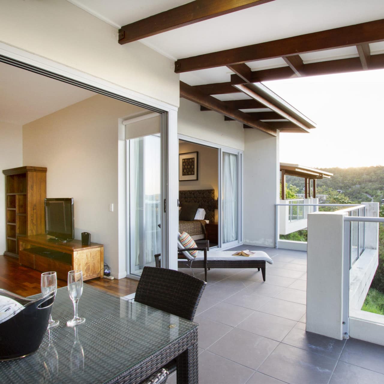 2-bedroom apartment with balcony, outdoor dining, lounge, living area and view of green hills