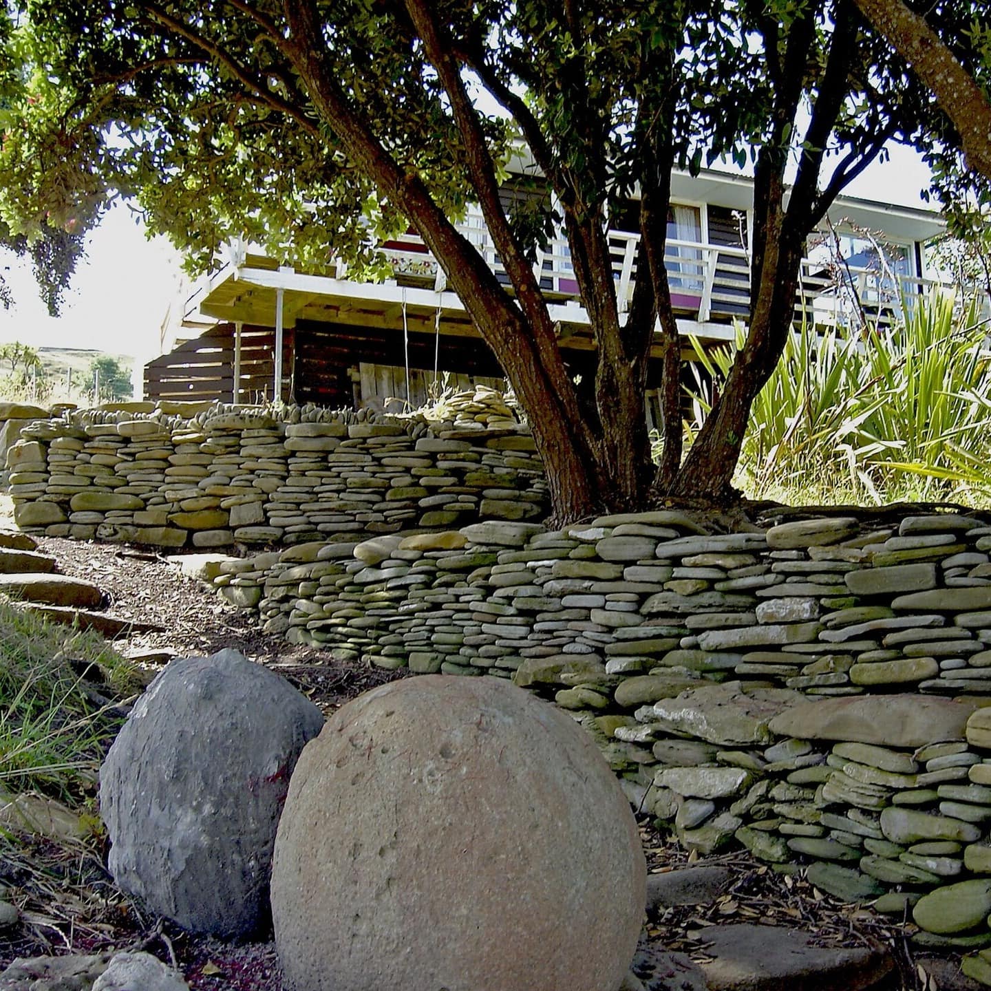 Tree and stonelined pathway leading to the holiday home
