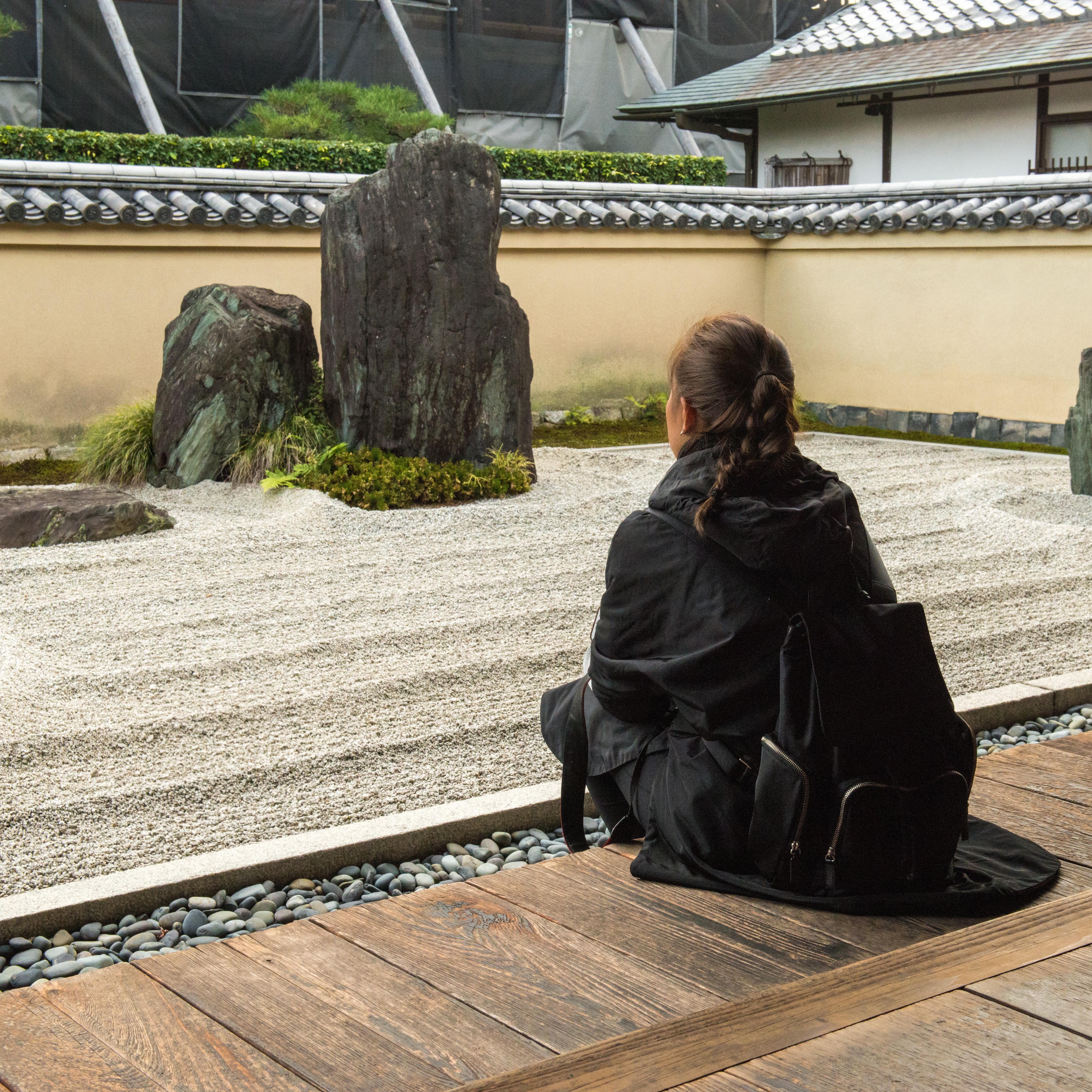 Girl relaxing by zen garden