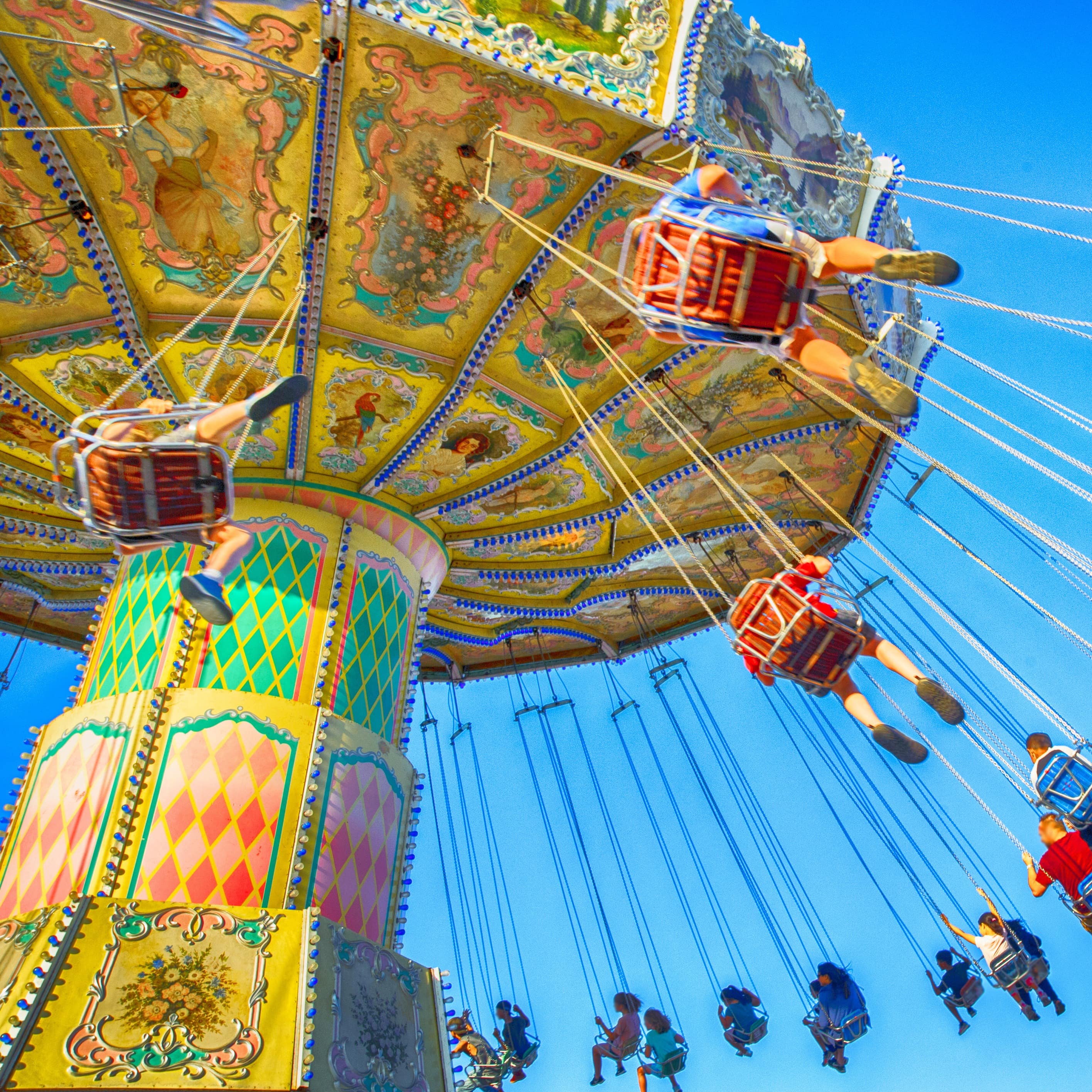 People riding swings at amusement park