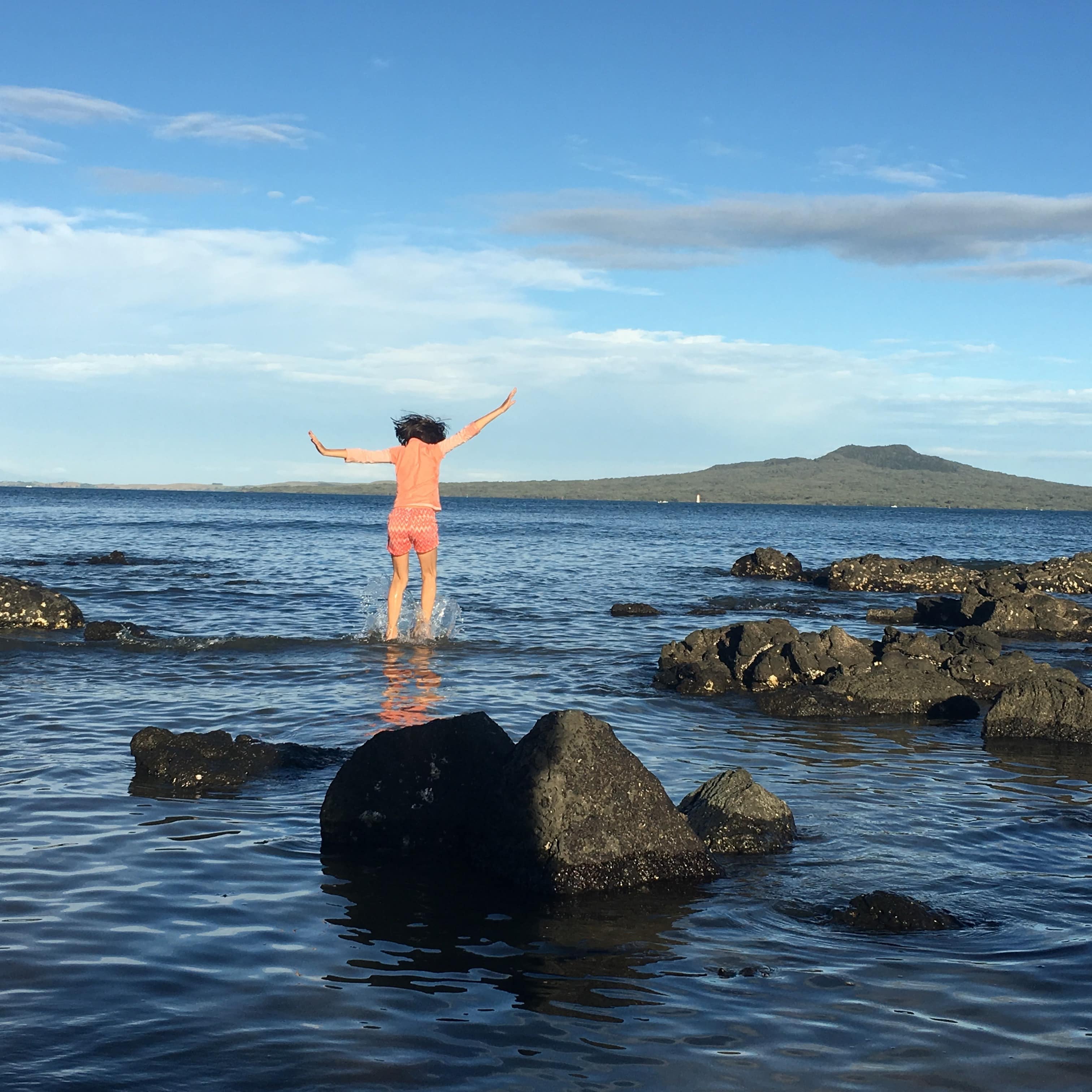 Female playing in the water near the rock formations