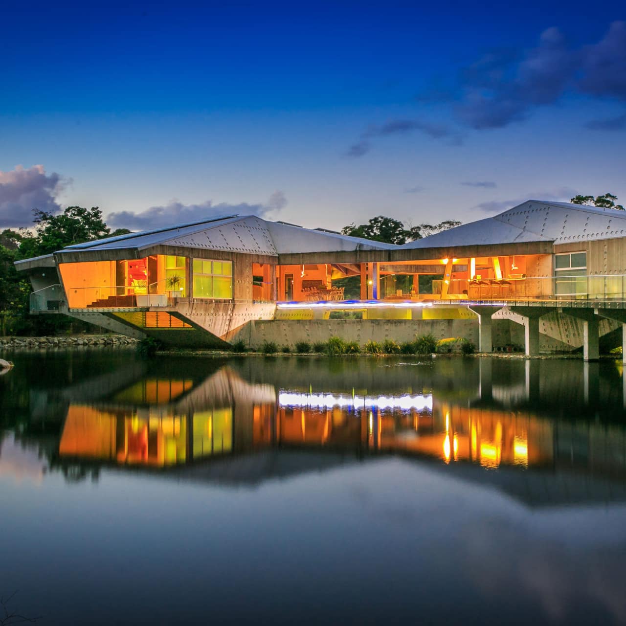 Lovely Alkira Resort, a 6-bedroom modern house sitting on the water with floor-to-ceiling windows and a concrete pier