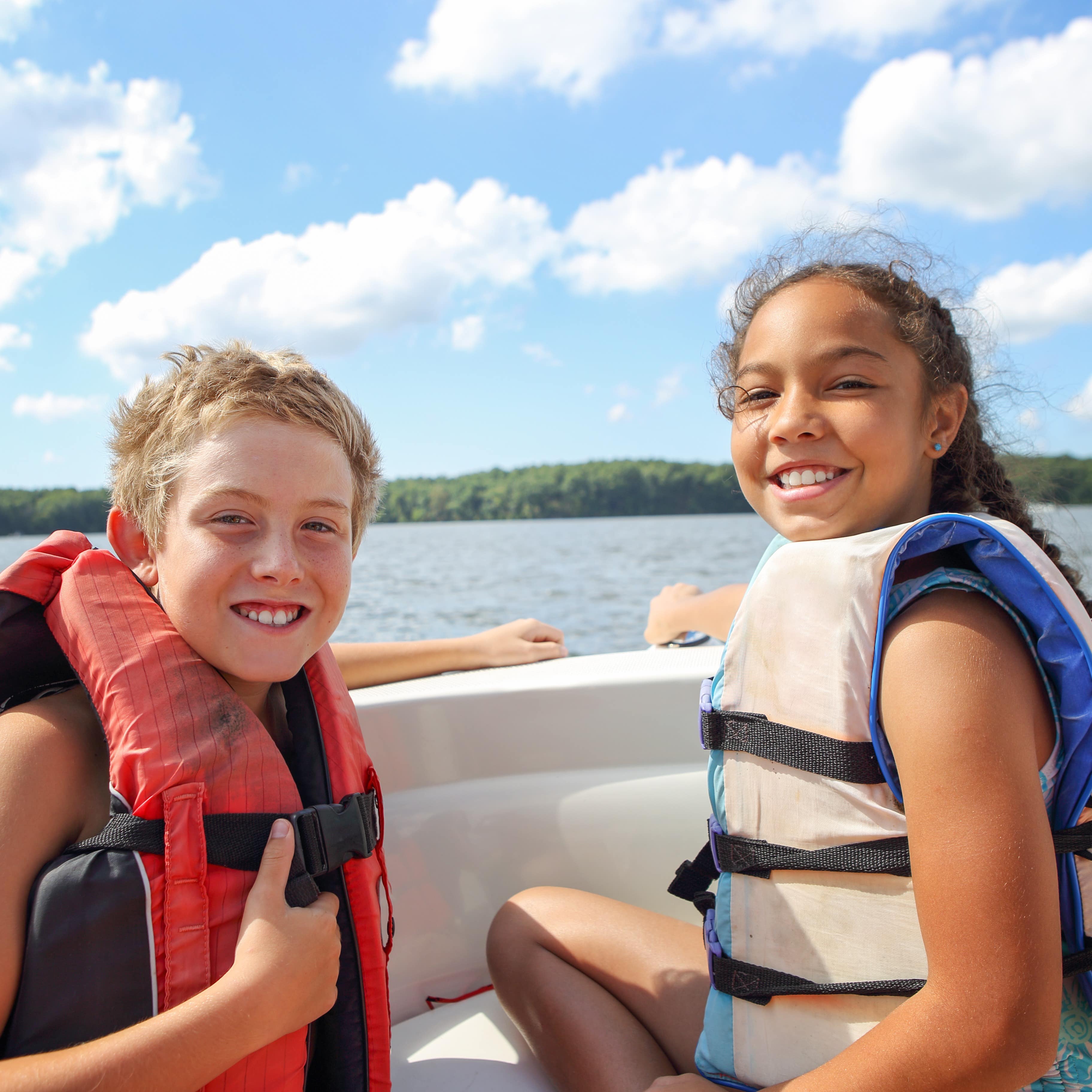 Two children sitting in a boat on the lake