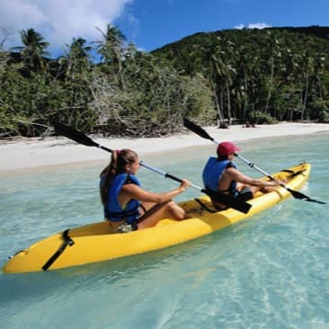 Couple kayaking off the coast