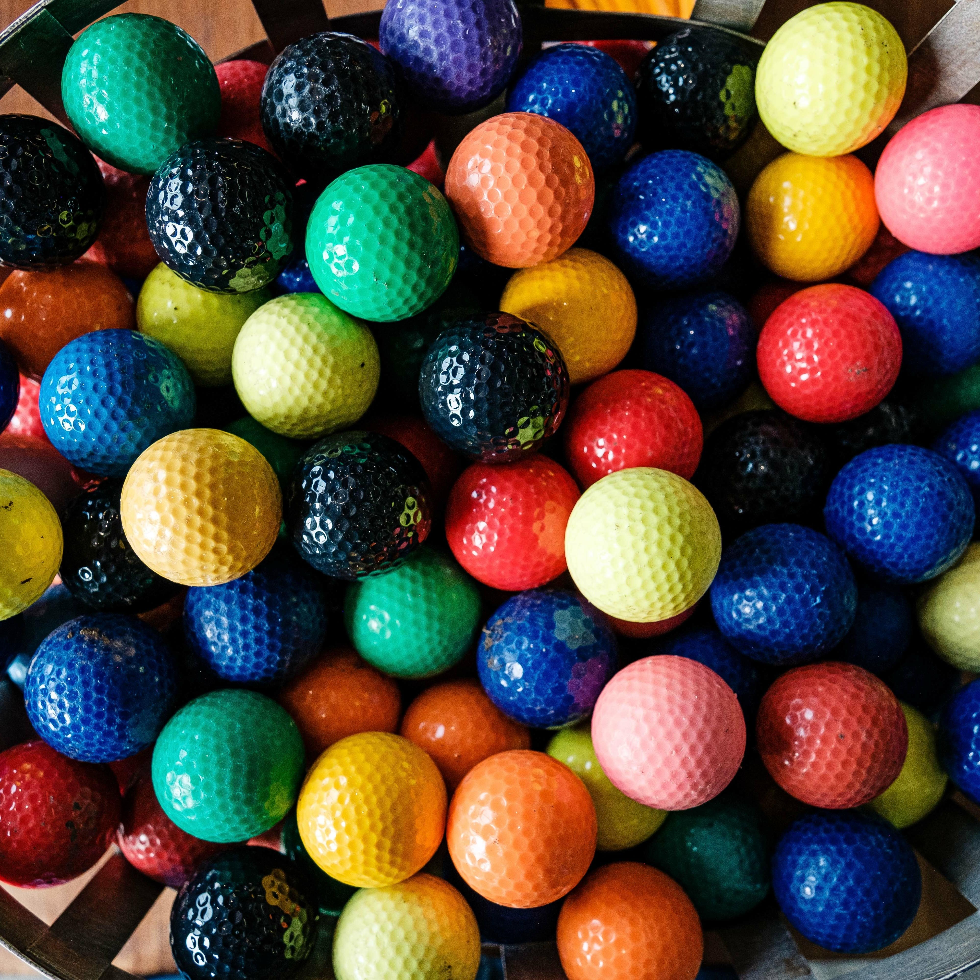 Bucket of colourful golf balls