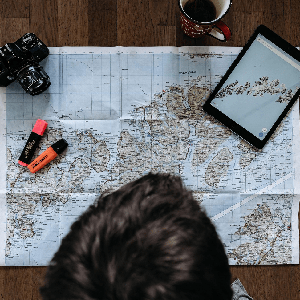 man with map, camera and coffee