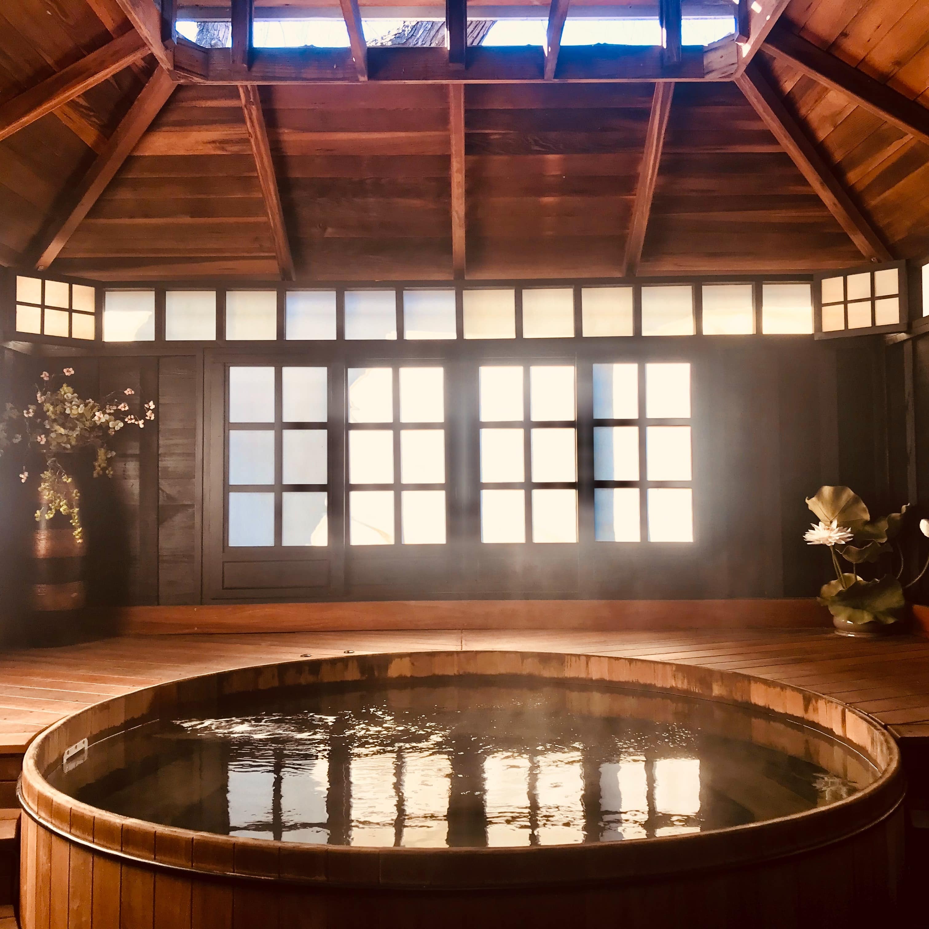 Wooden hot pool tub with steam rising