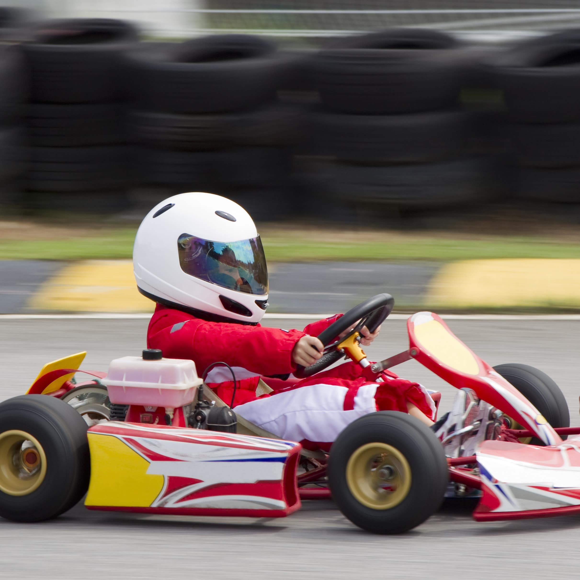 Young boy racing a go-kart