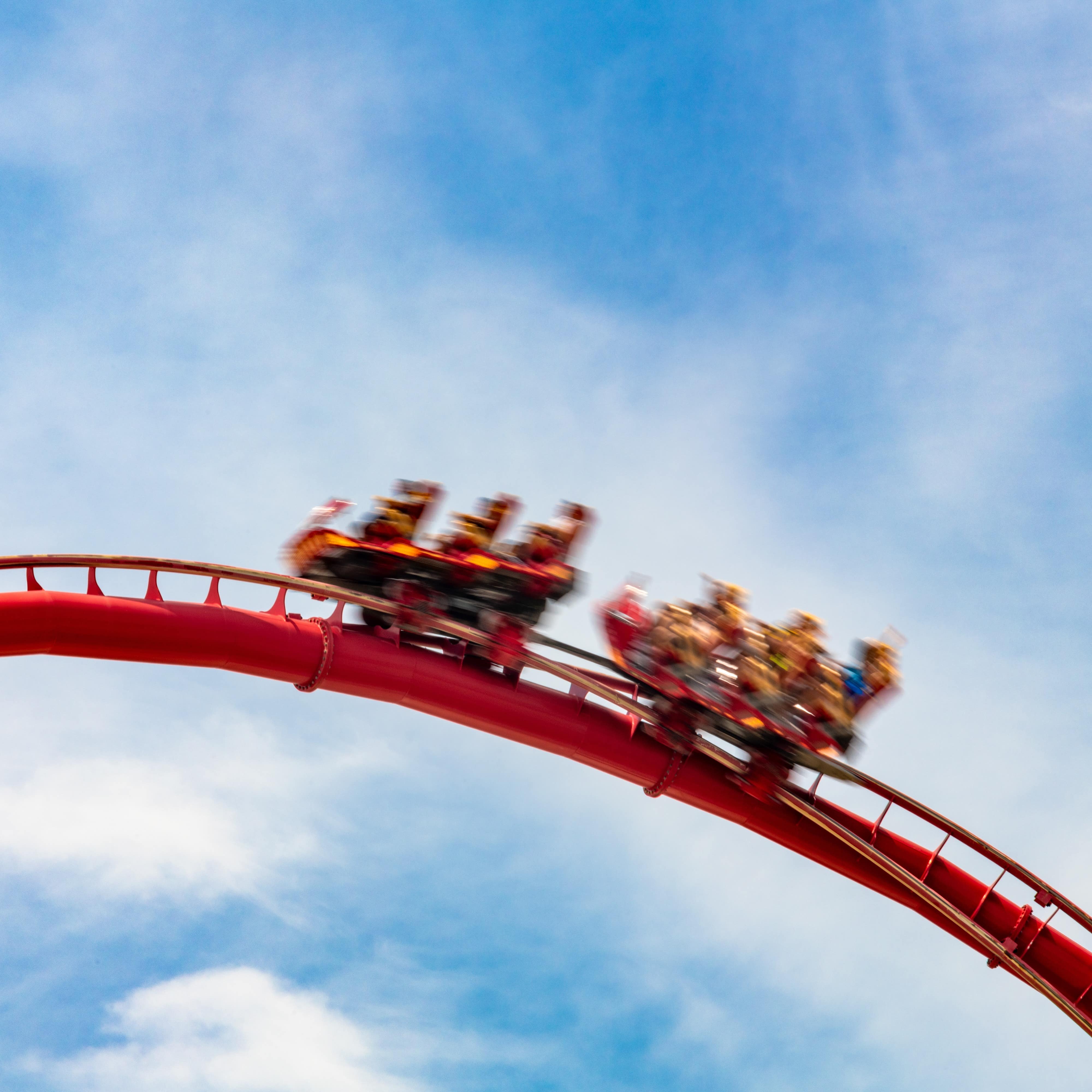 Motion blur of people on a corkscrew rollercoaster