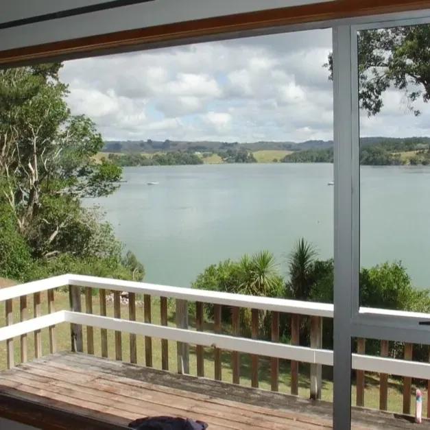 Looking through window of a bach at the deck and lake view