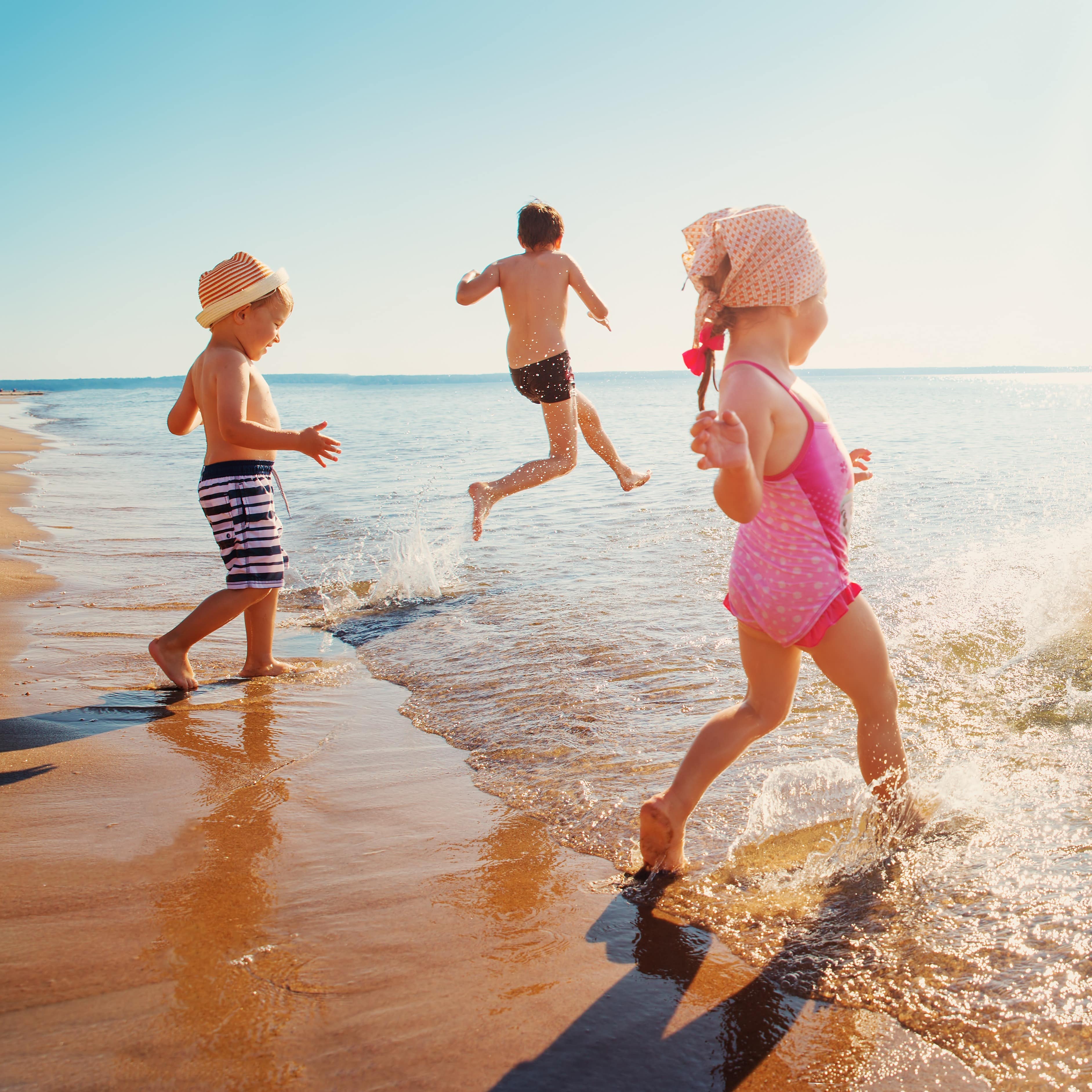 Kids running into the ocean