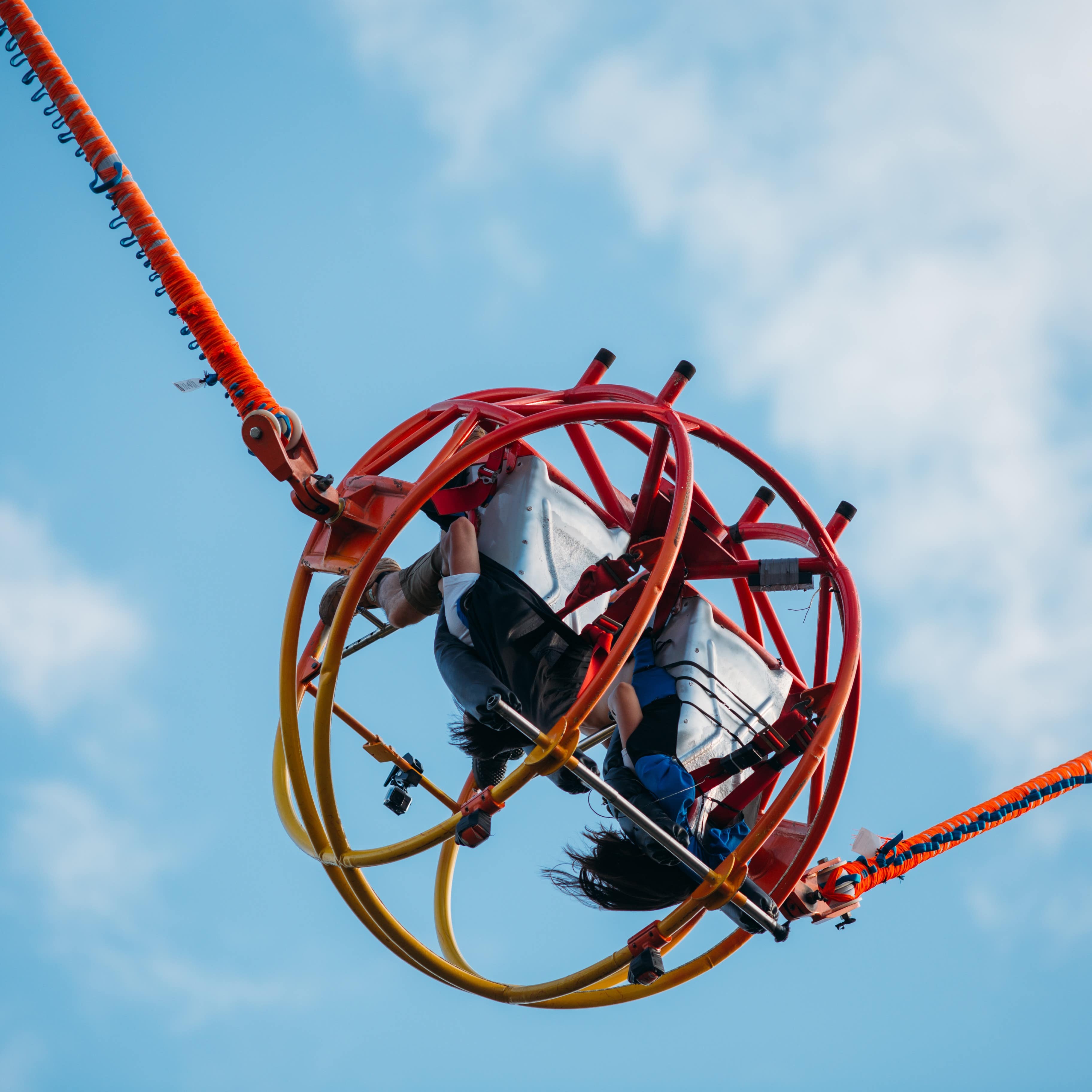 Two people riding a reverse bungee ride