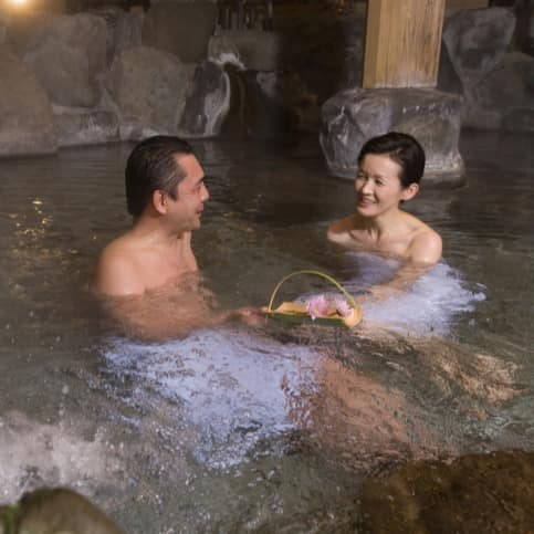 Couple soaking in a natural hot spring