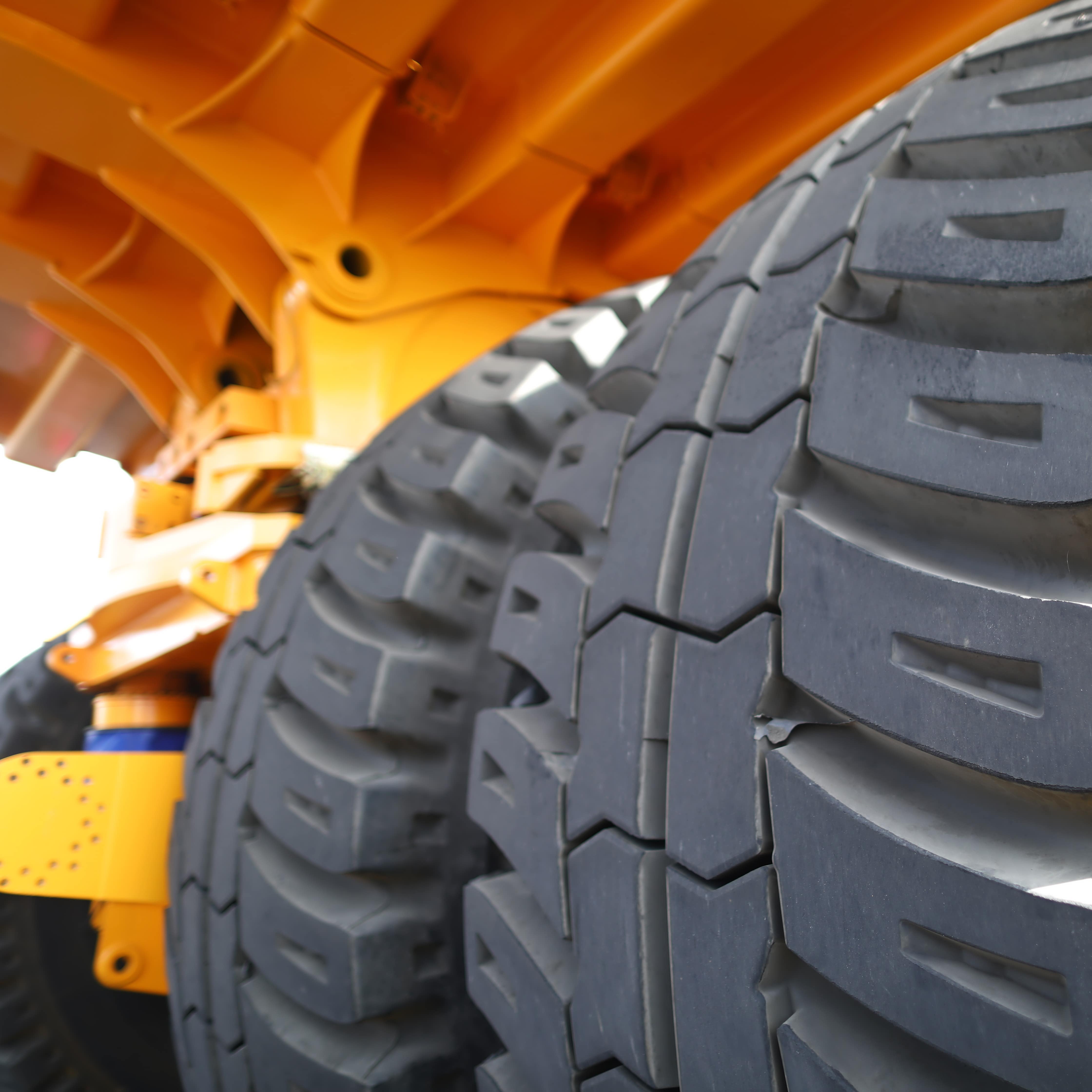 Huge rear wheels of a dump truck at unusual angle closeup