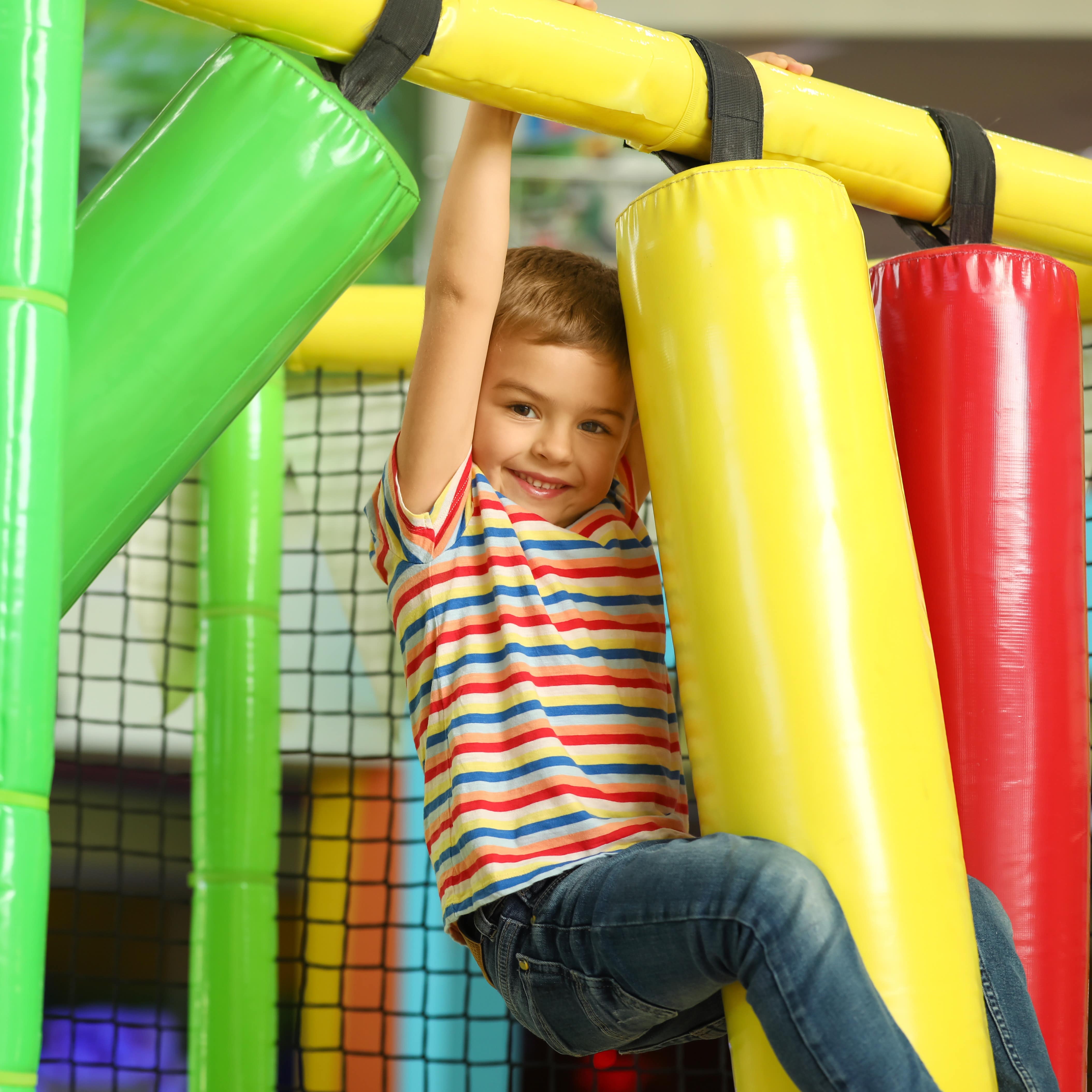 Little boy playing at indoor playground