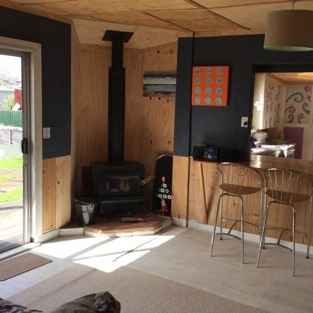 Lounge area with a fireplace and a view of the kitchen